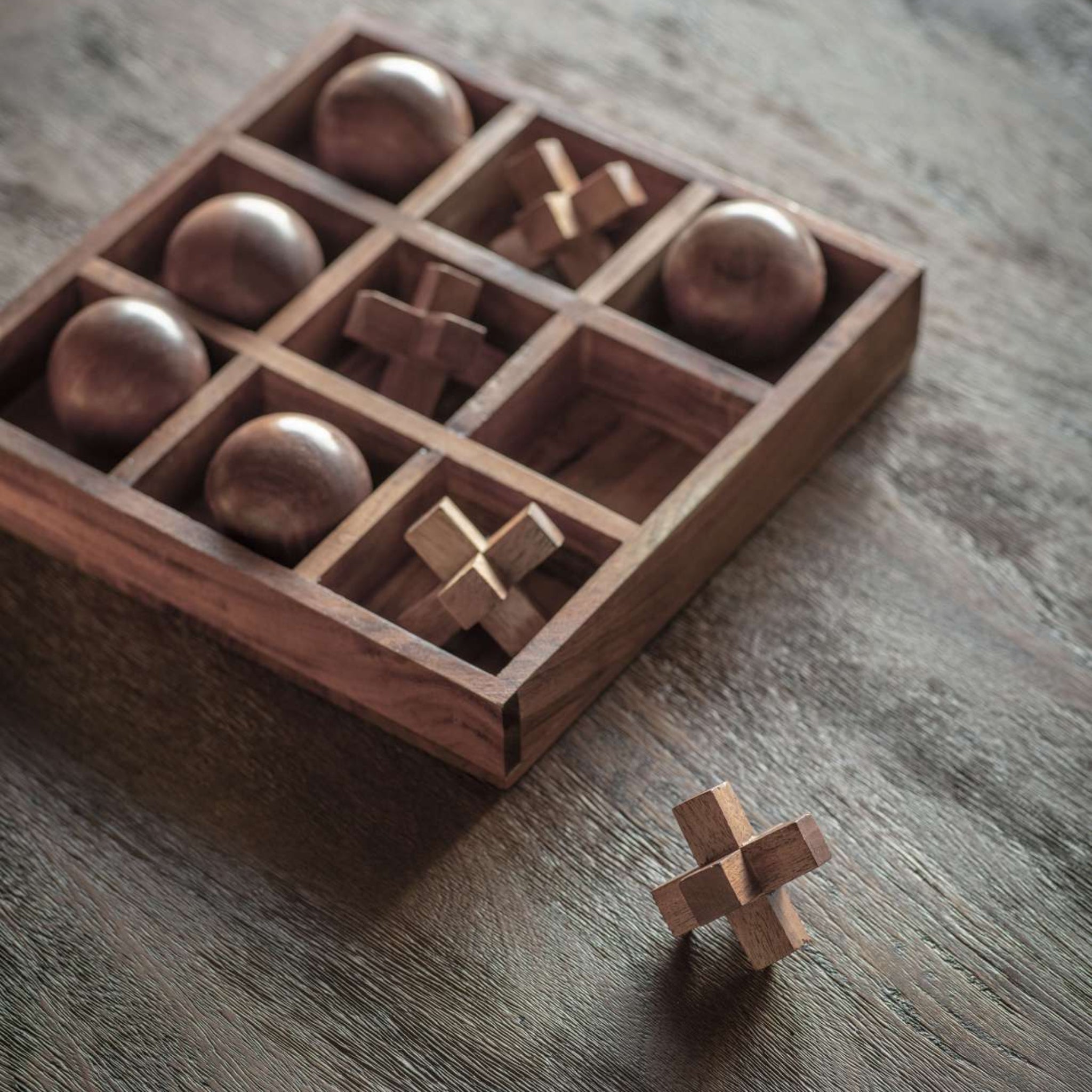 Wooden puzzle box with geometric shapes on a wooden surface