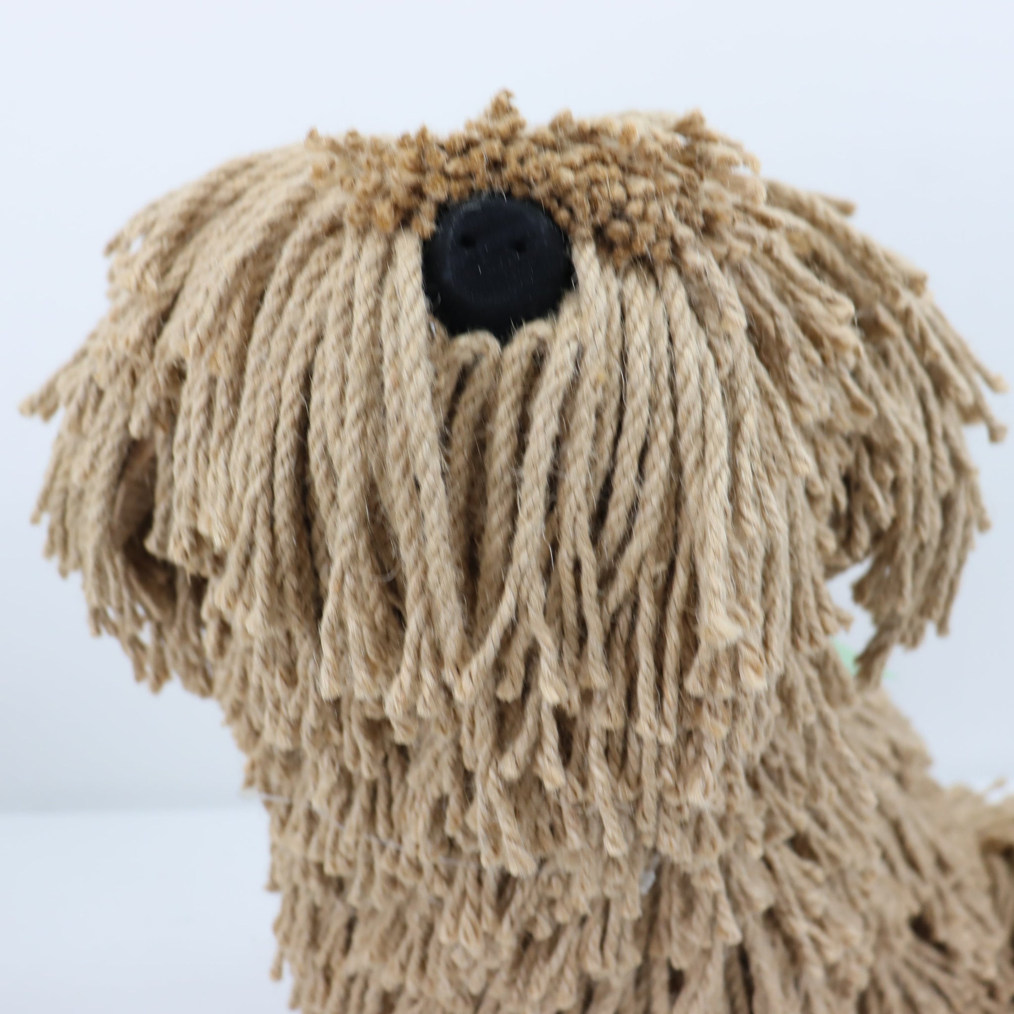 Close-up of a dog toy with braided texture on a white background
