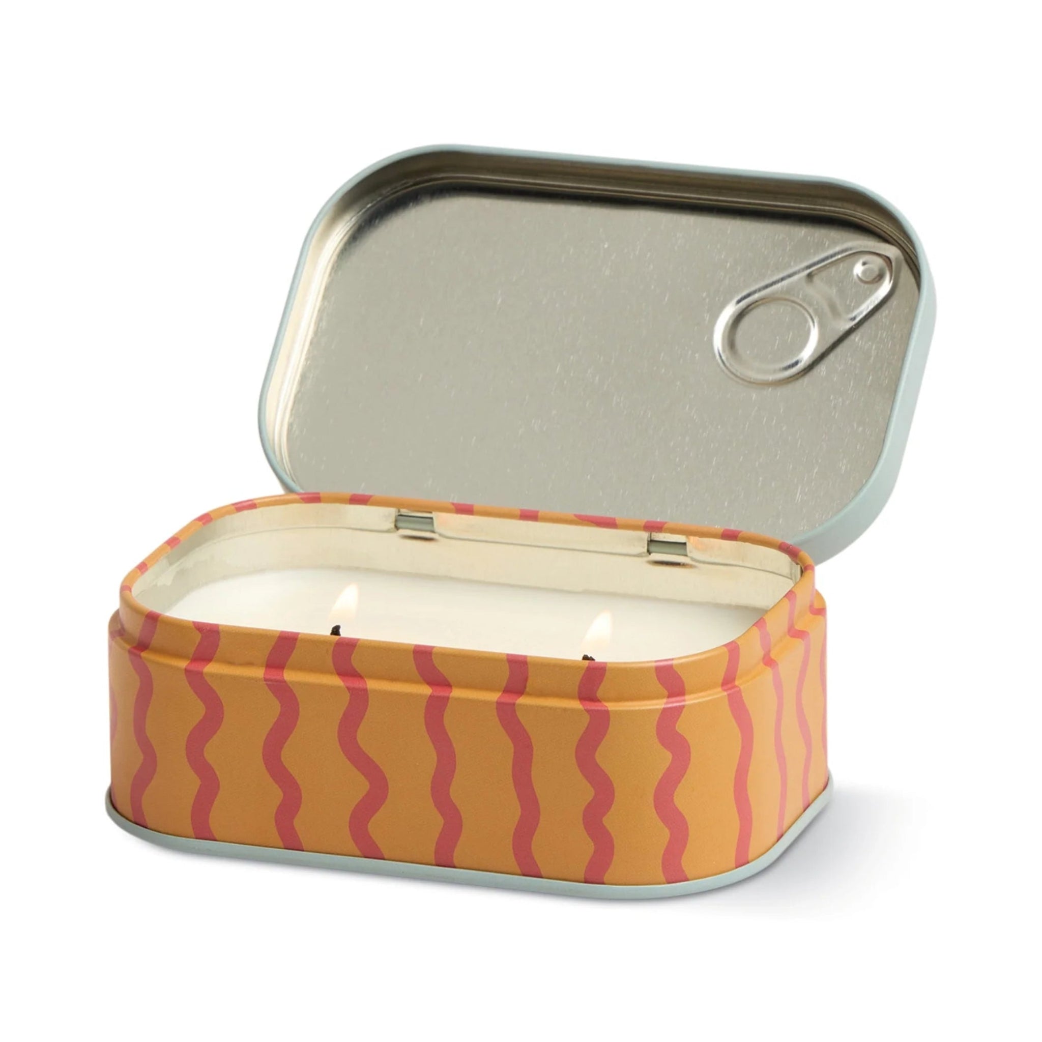 Candle in a tin with wavy pattern on a white background