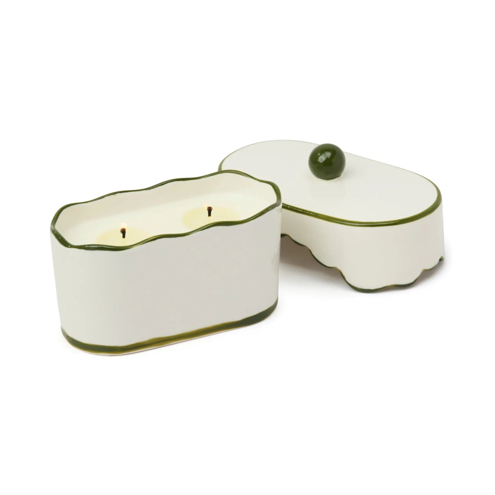 White ceramic candle holder with green rim on a white background