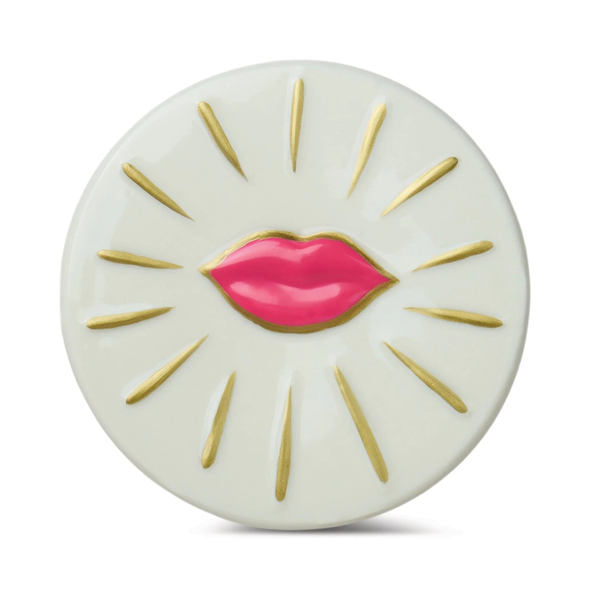 Round white object with pink lips and gold accents on a white background
