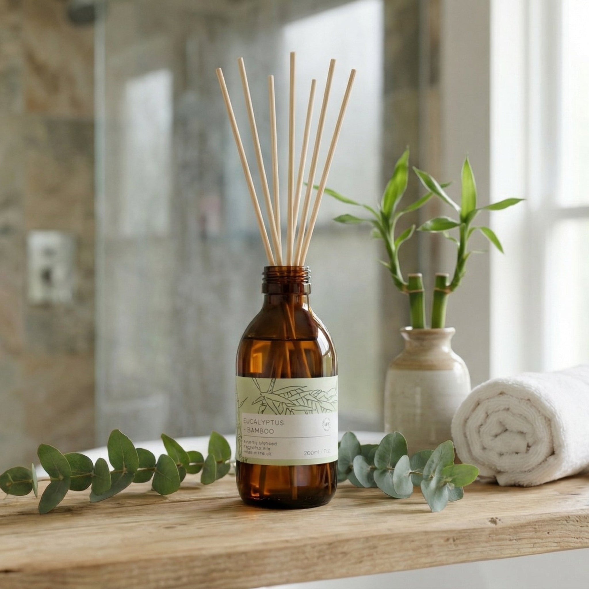 Aromatherapy diffuser on a bathroom counter with towels and plants in the background