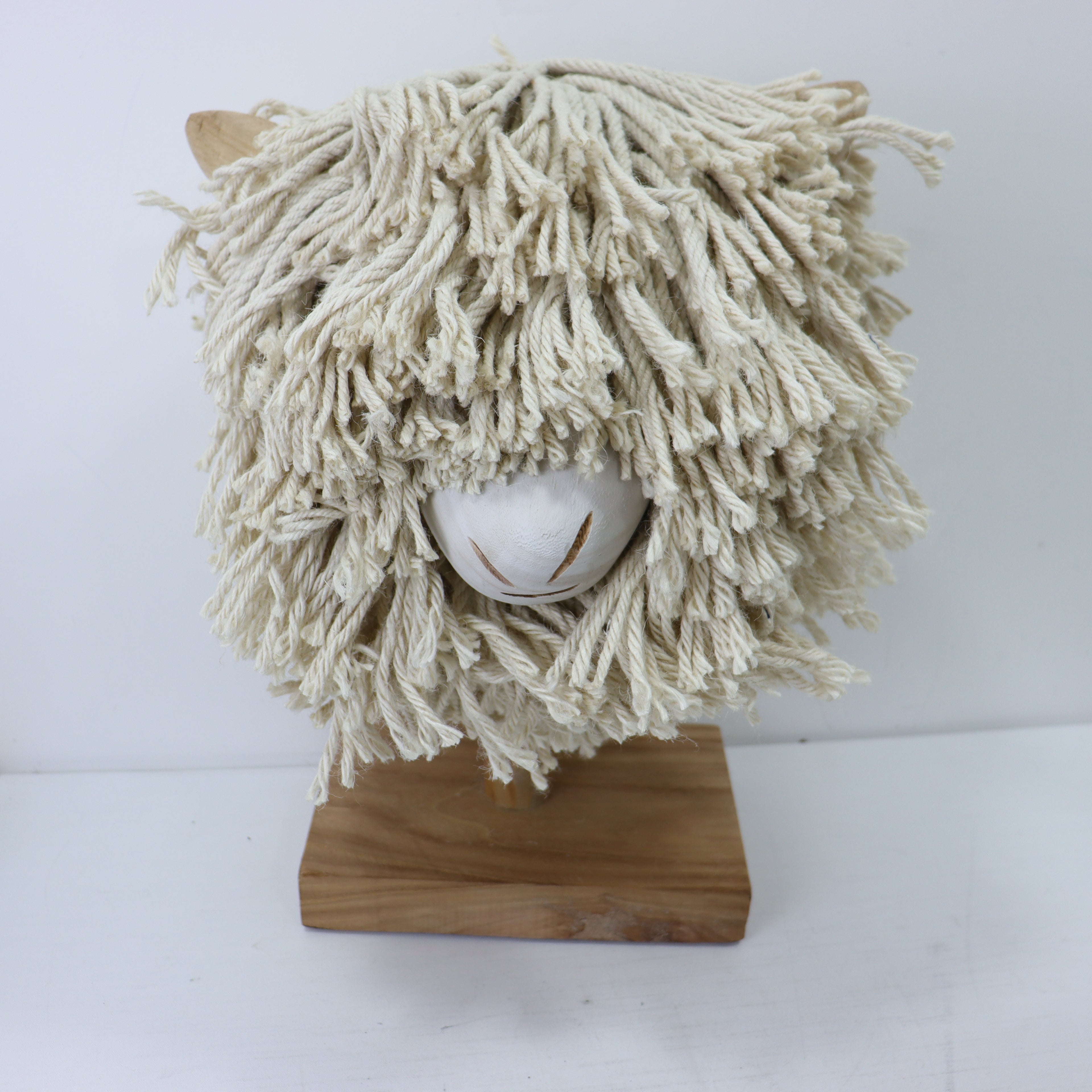 a white mop on a wood stand