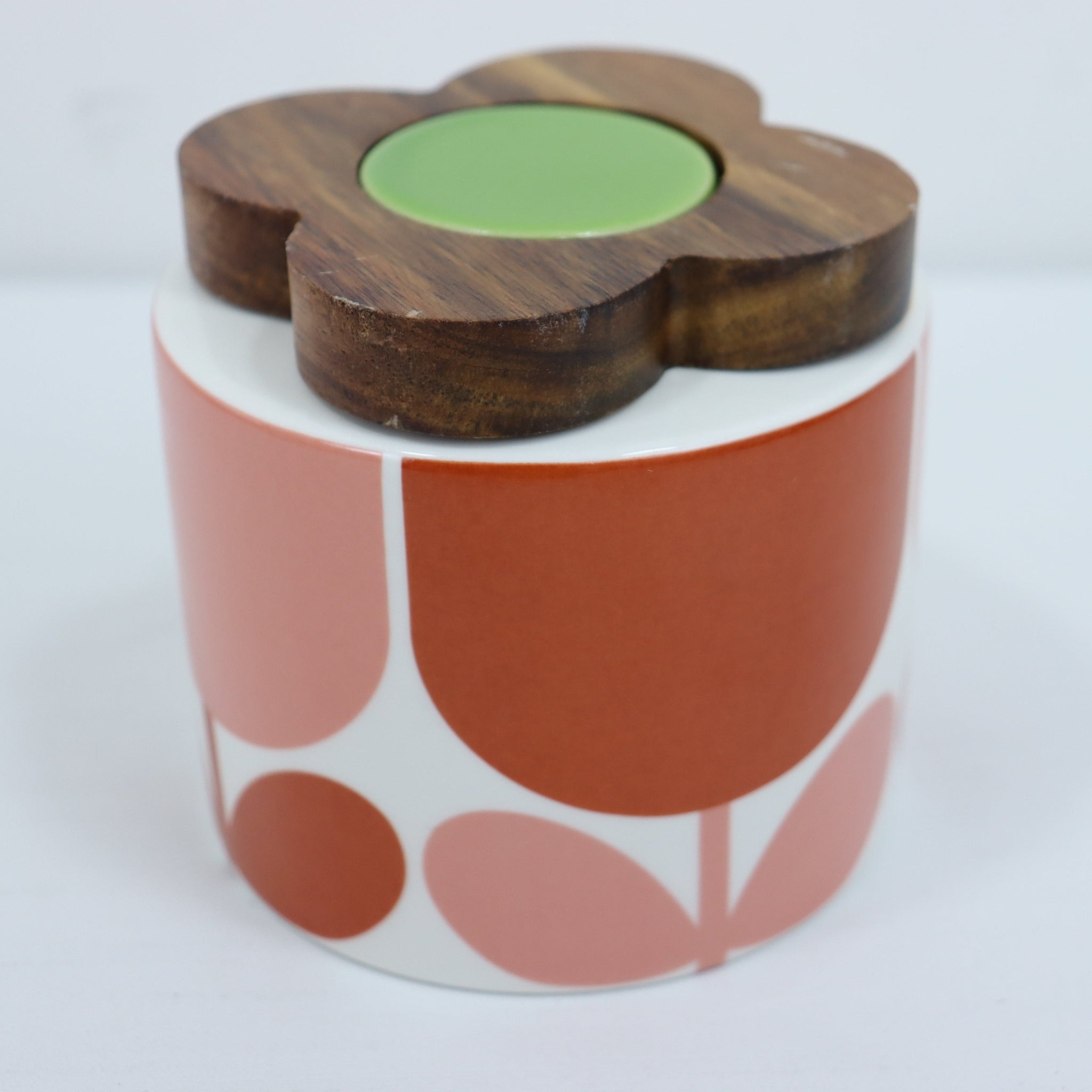 Decorative container with a wooden flower-shaped lid on a white background