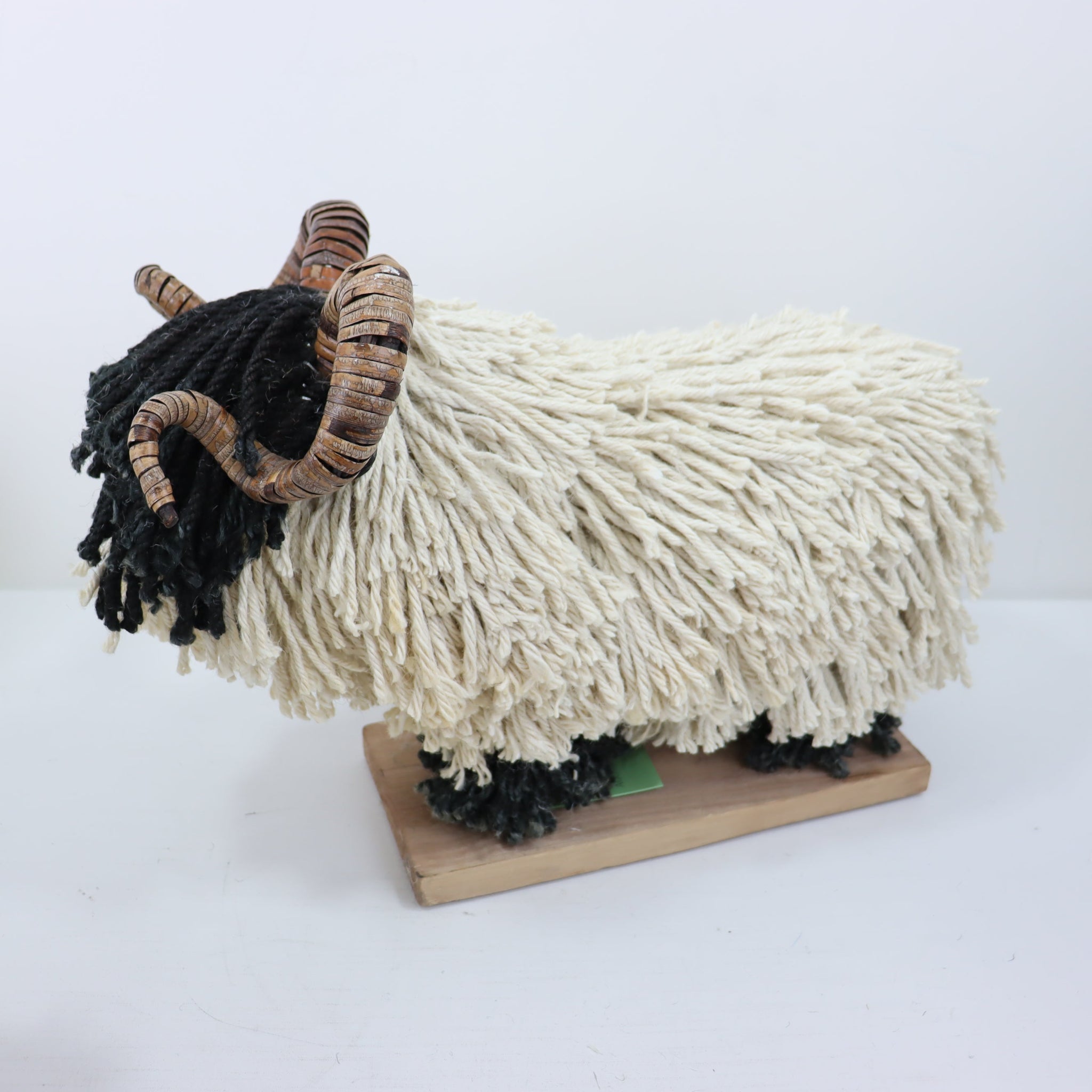 Aquarelle Home Rupert Sheep with horns side view. Black face with cream body