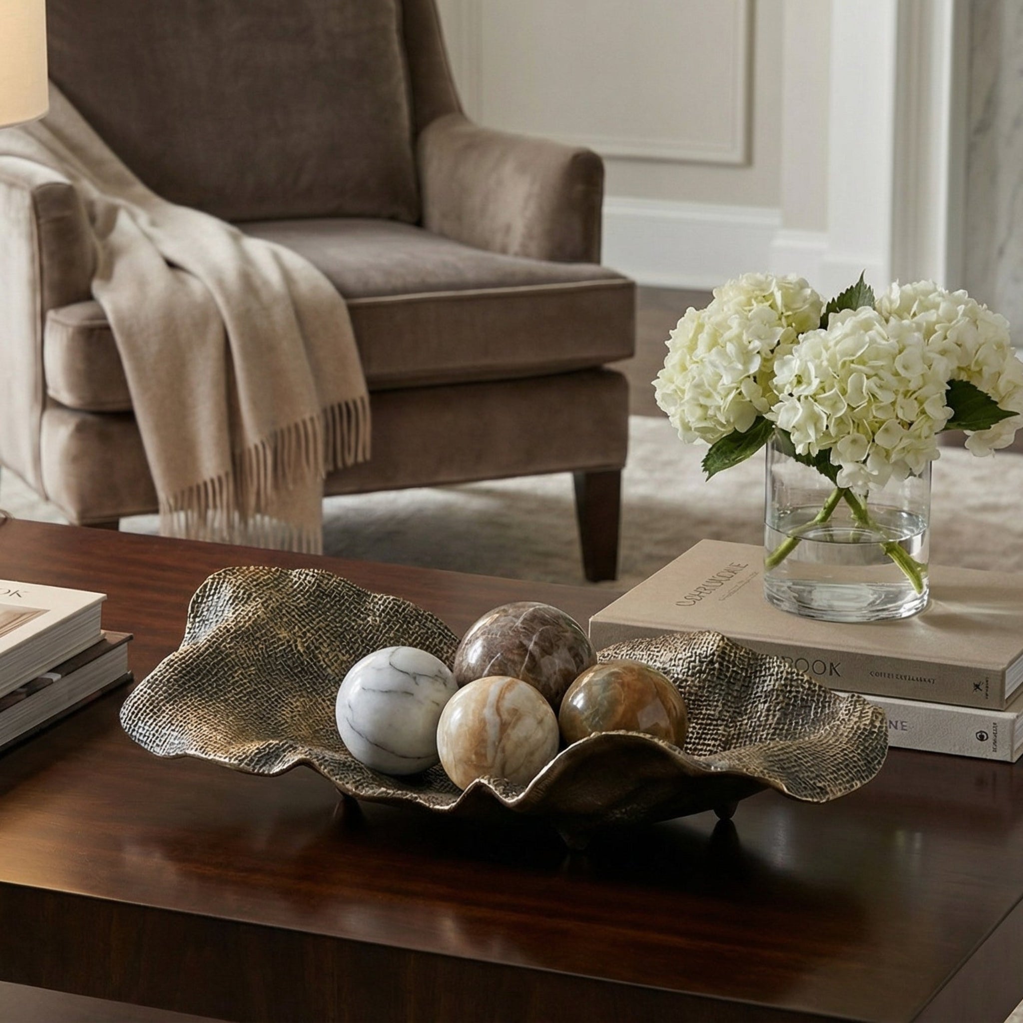 Living room with a coffee table, armchair, and decorative items.