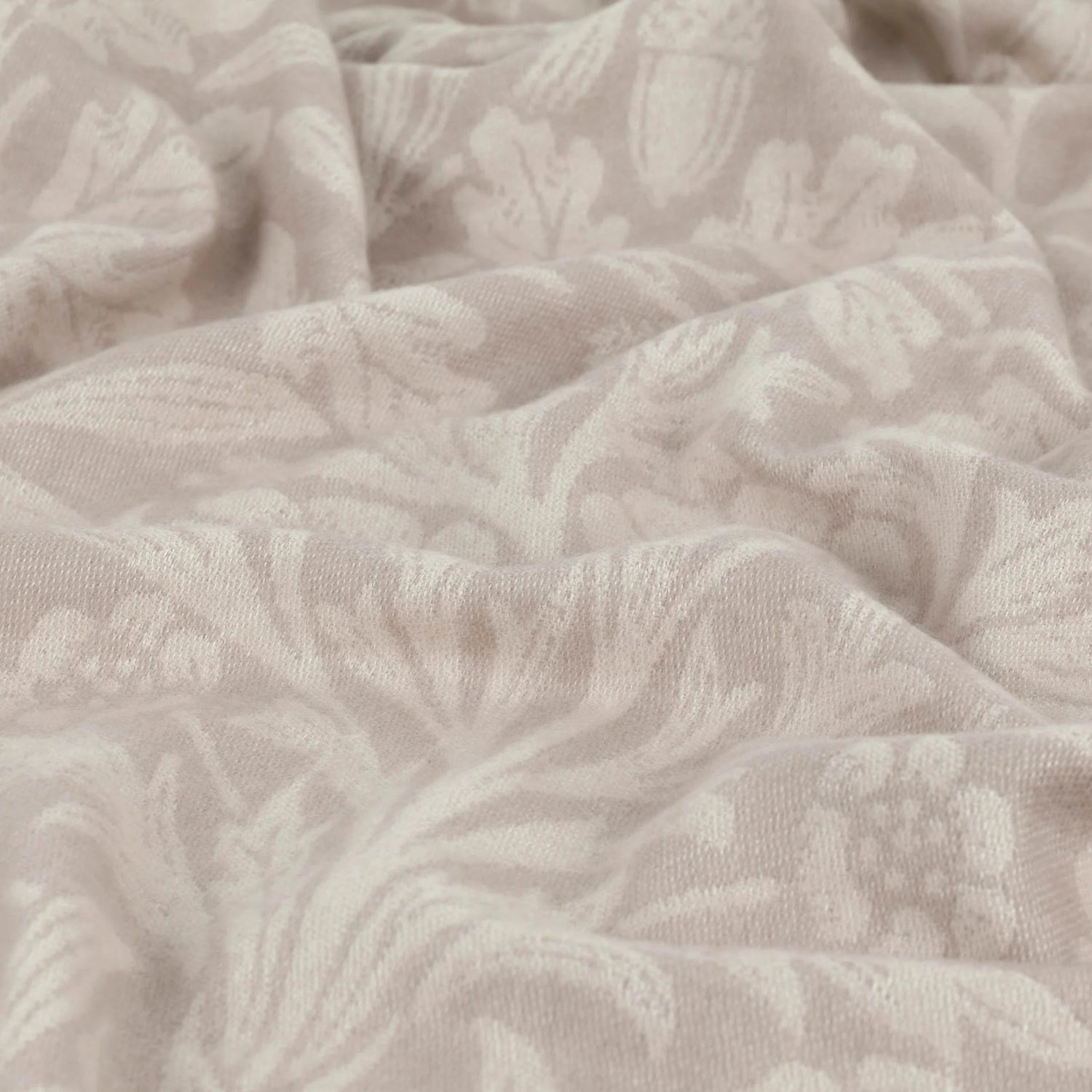 Close-up of textured beige fabric with a subtle pattern