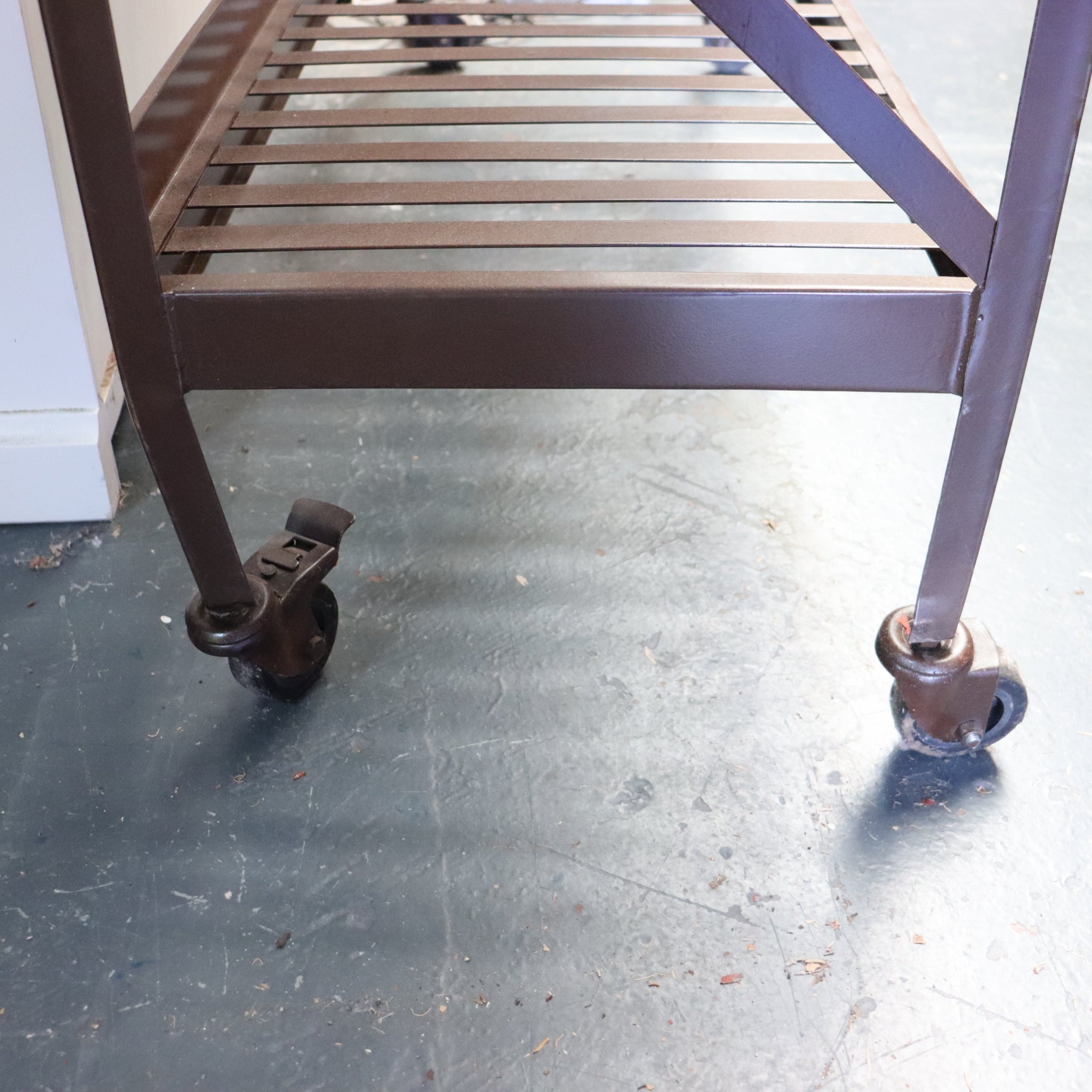 Metal rolling cart with wheels on a concrete floor
