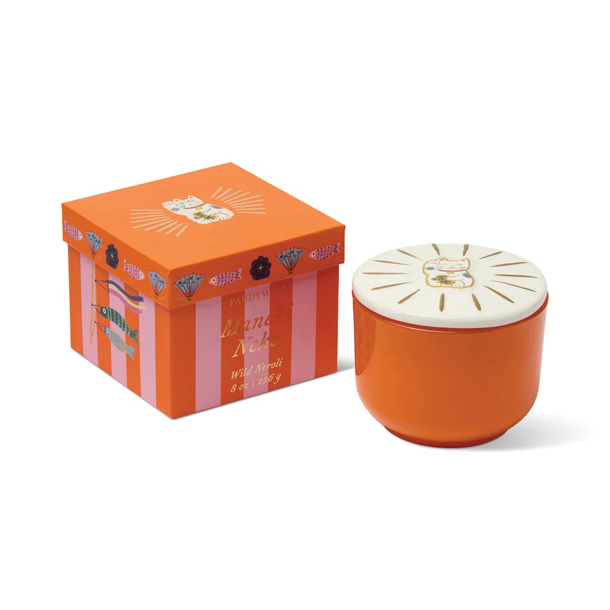 Orange candle with decorative lid and matching box on a white background