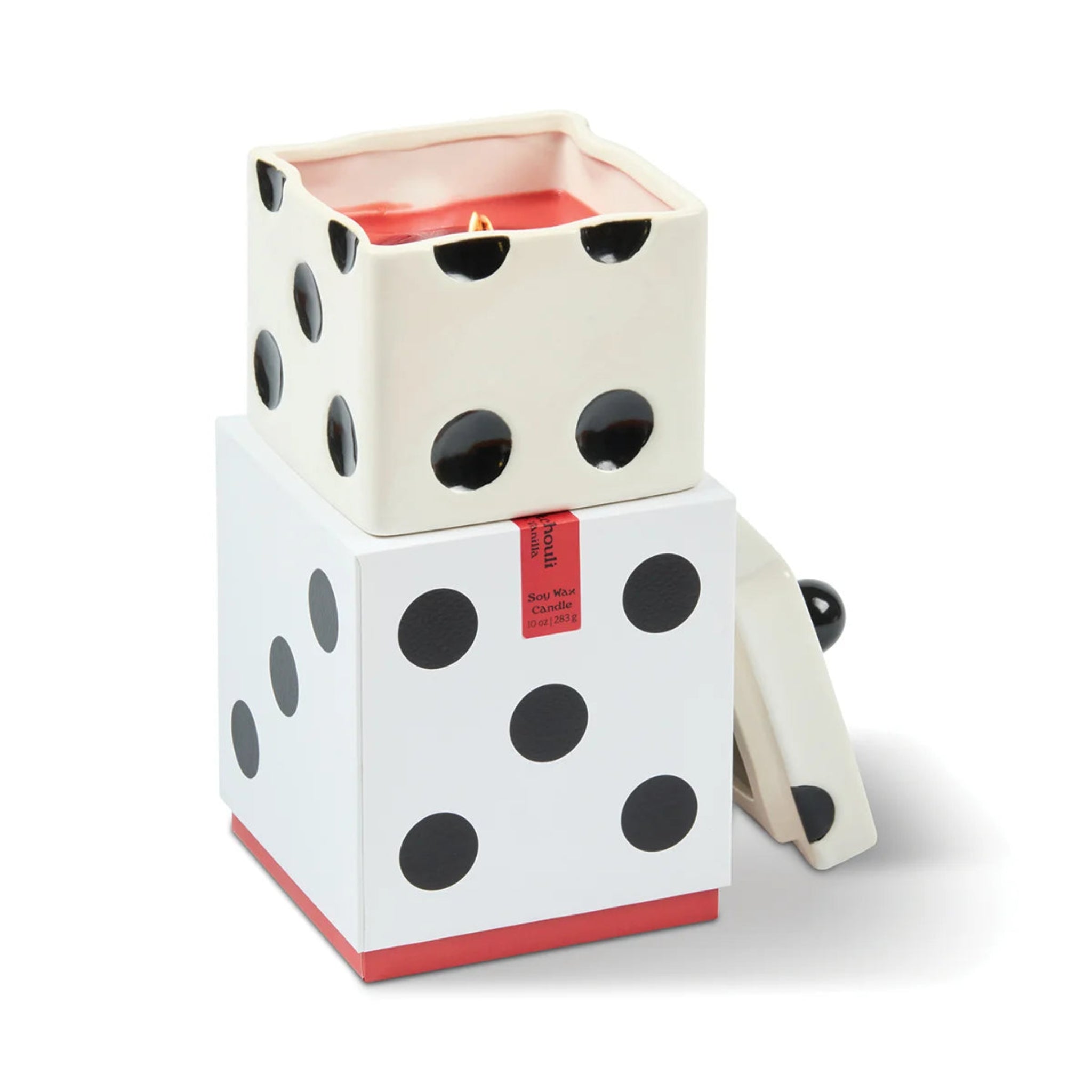 A novelty dice-shaped candle holder and candle set, featuring a white and black polka-dotted die design with a red wax candle inside, shown on a clean white background.