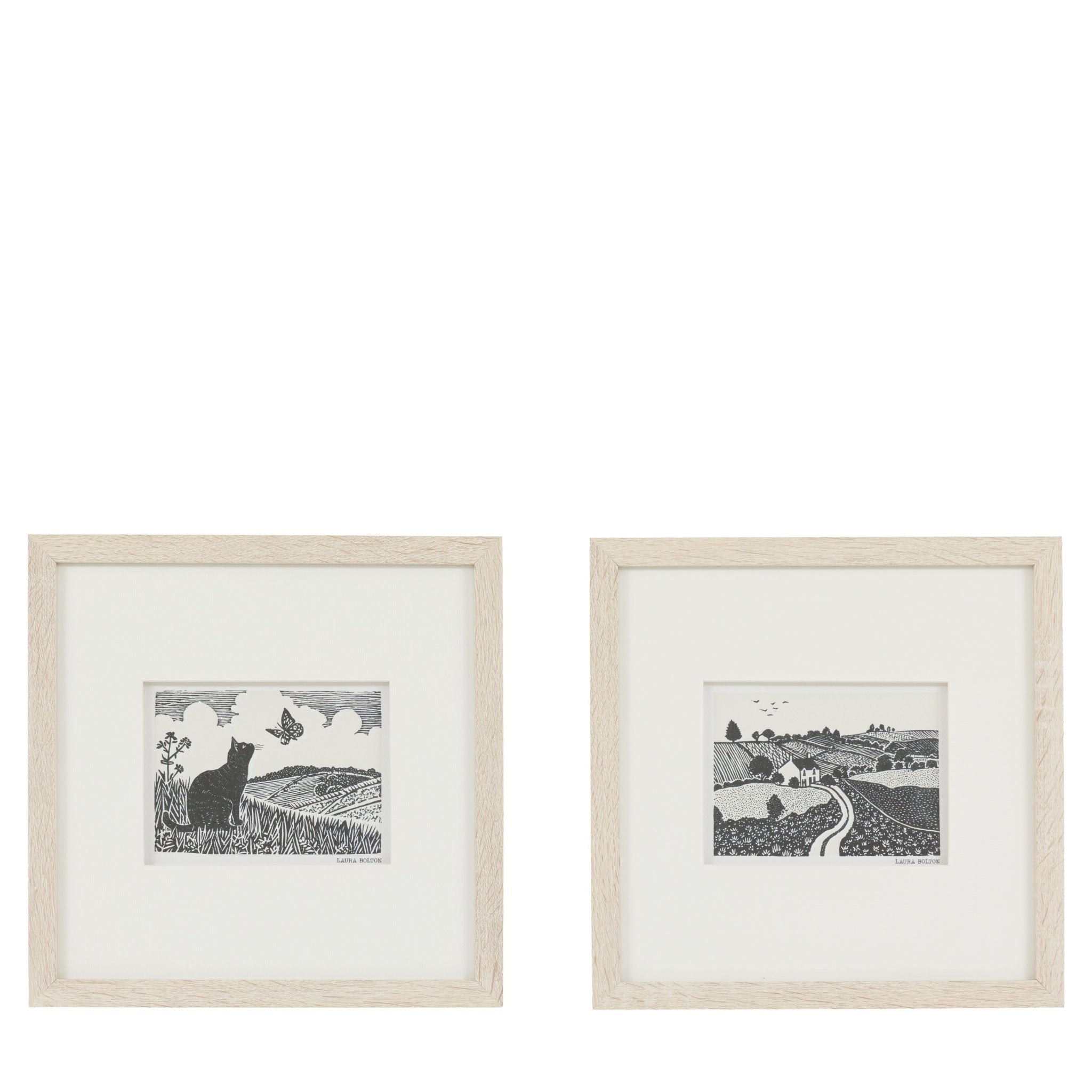 Two framed black and white prints of landscapes on a white background