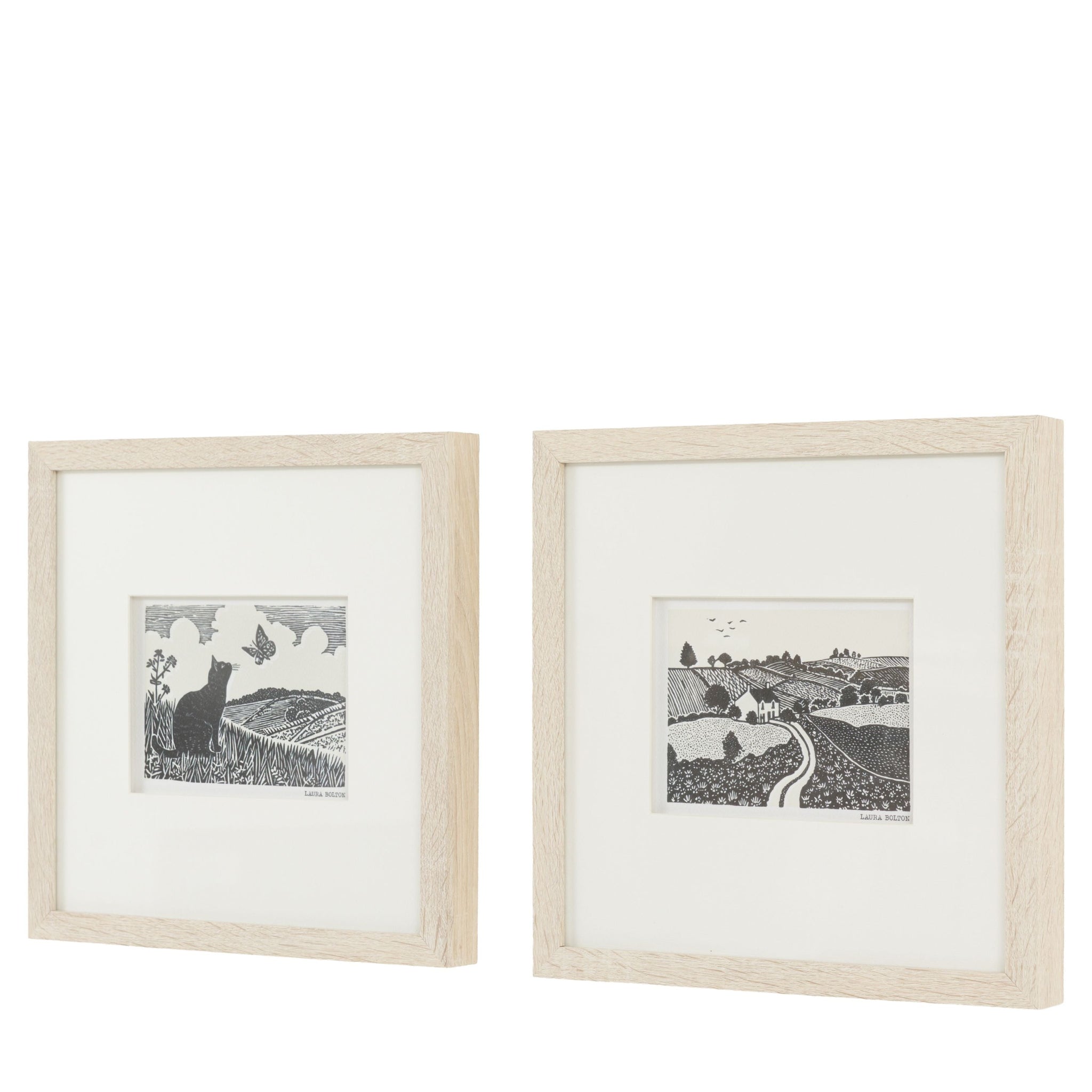 Two framed black and white prints of landscapes on a white background