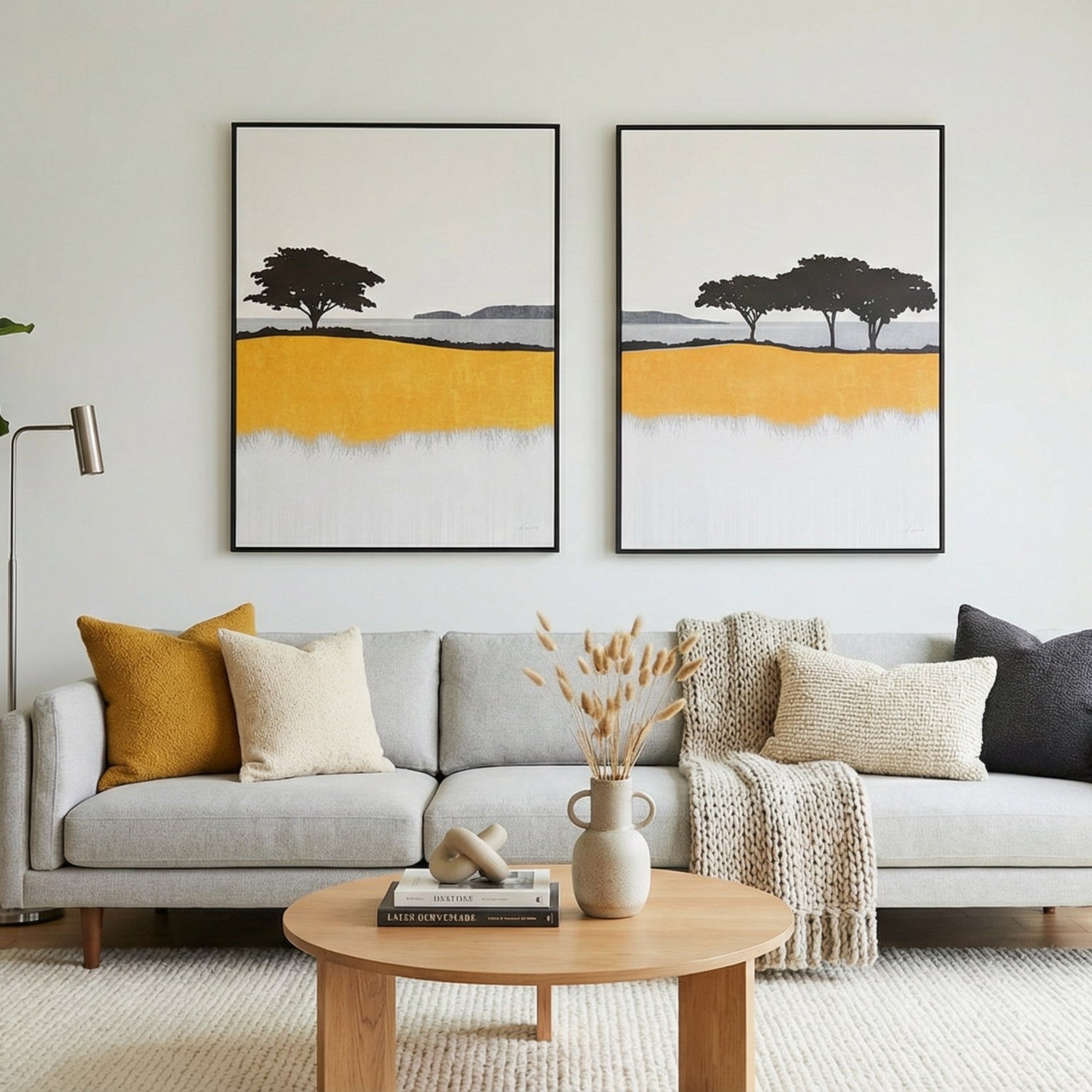 Living room with a gray sofa, wooden coffee table, and two abstract wall art pieces.