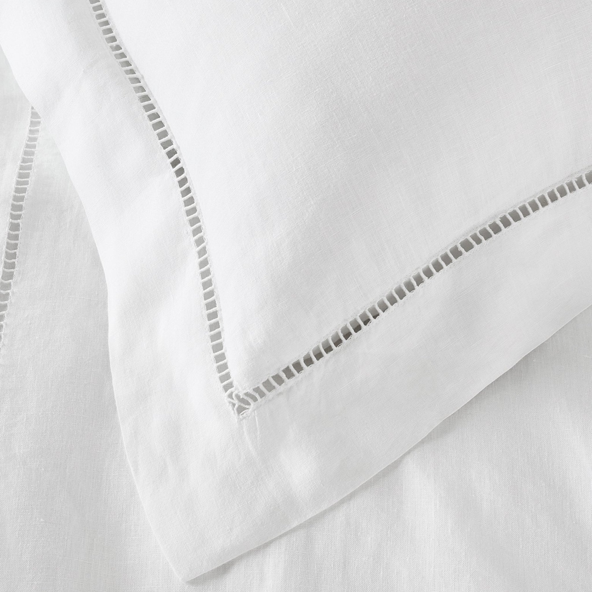 Close-up of white fabric with decorative stitching
