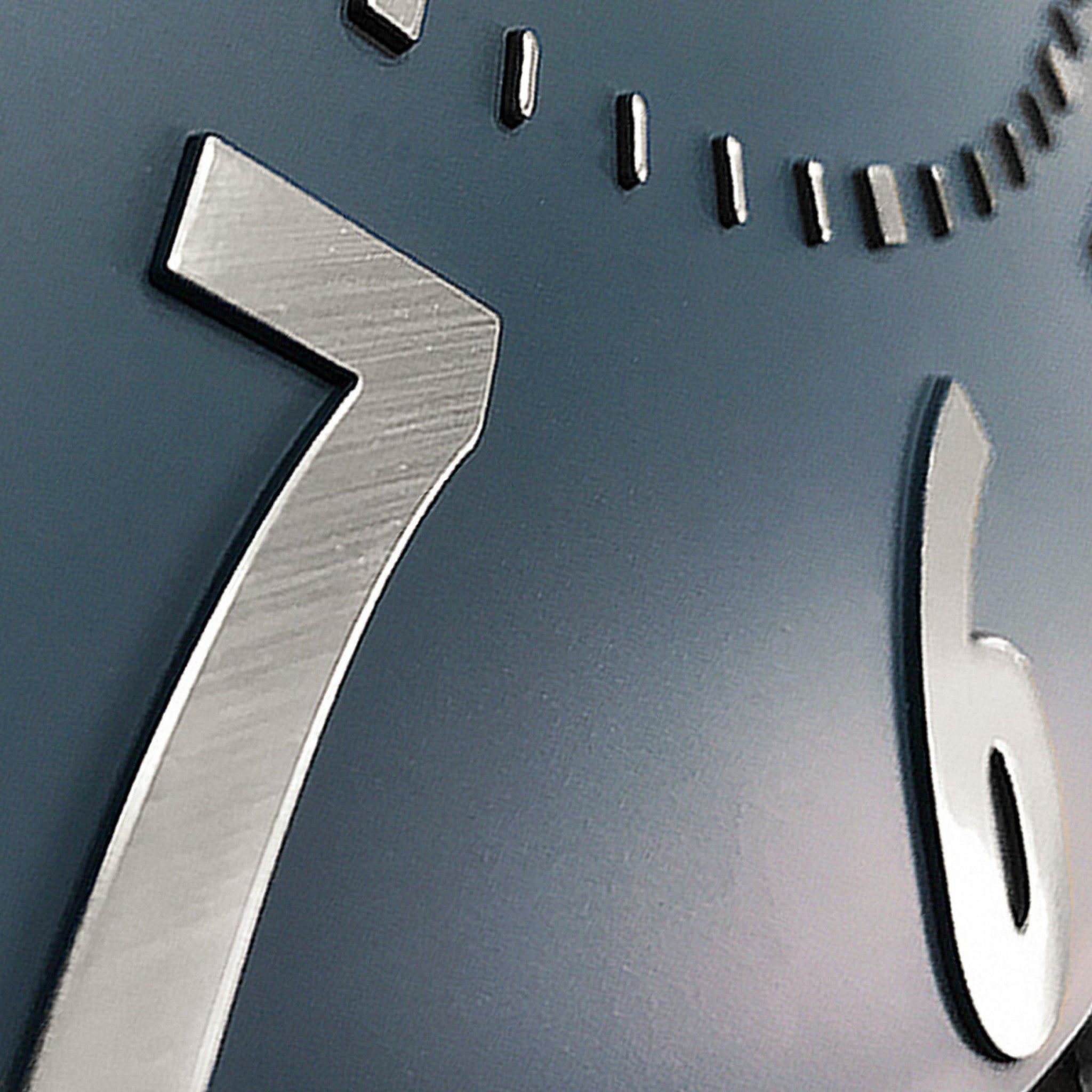 Close-up of a clock face with metallic numbers &