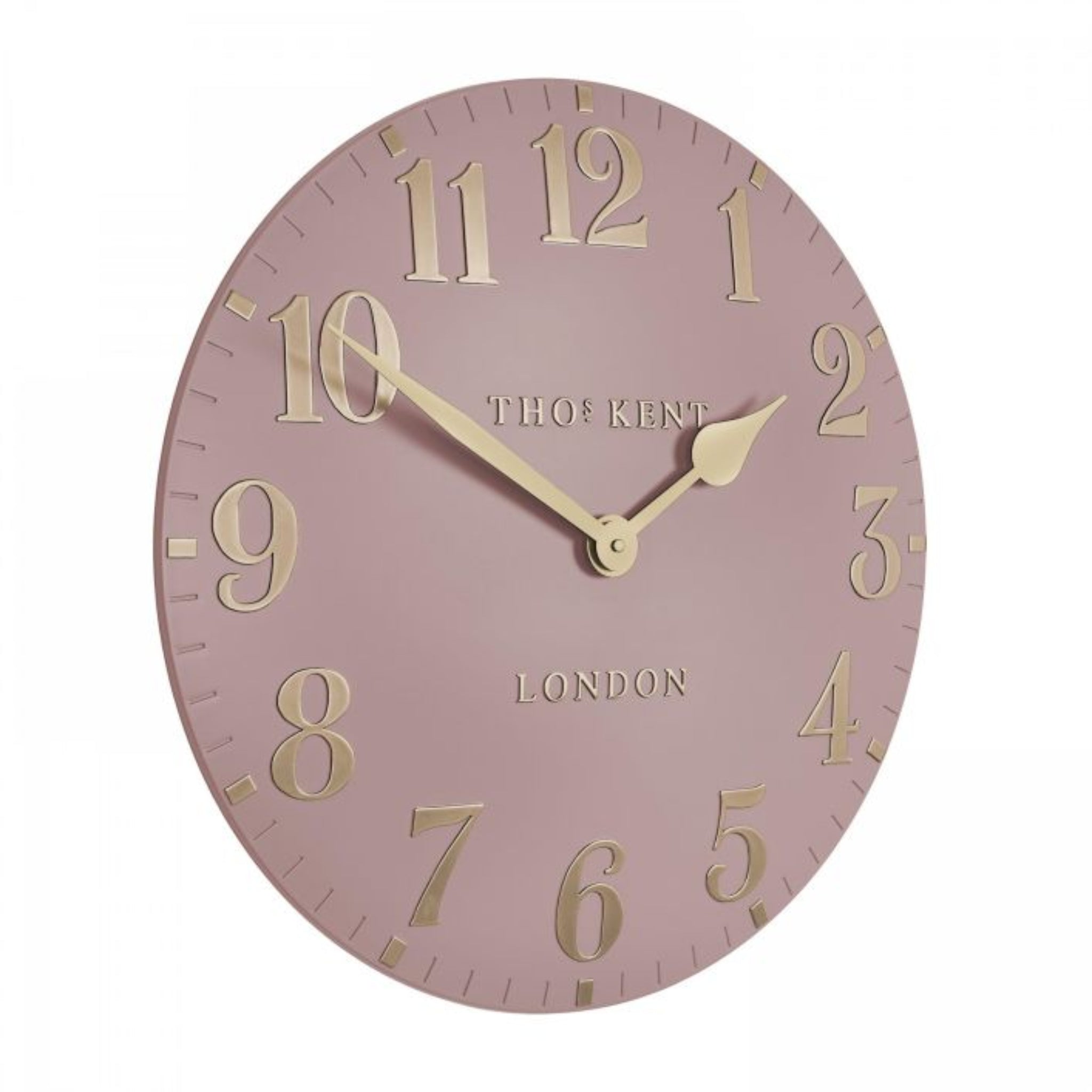 Pink wall clock with gold numbers and brand name on a white background