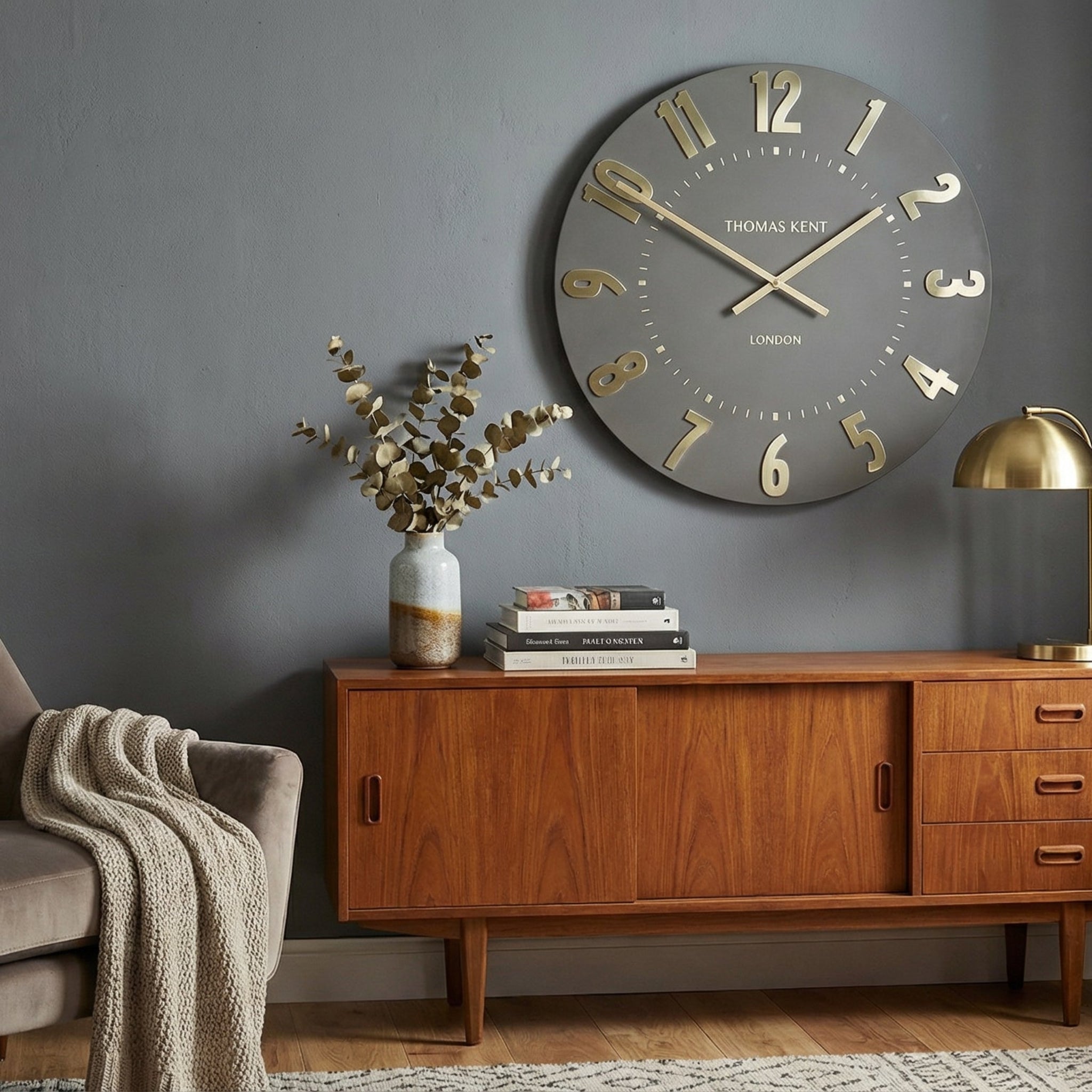 Living room with a wooden sideboard, armchair, and decorative clock on a gray wall.