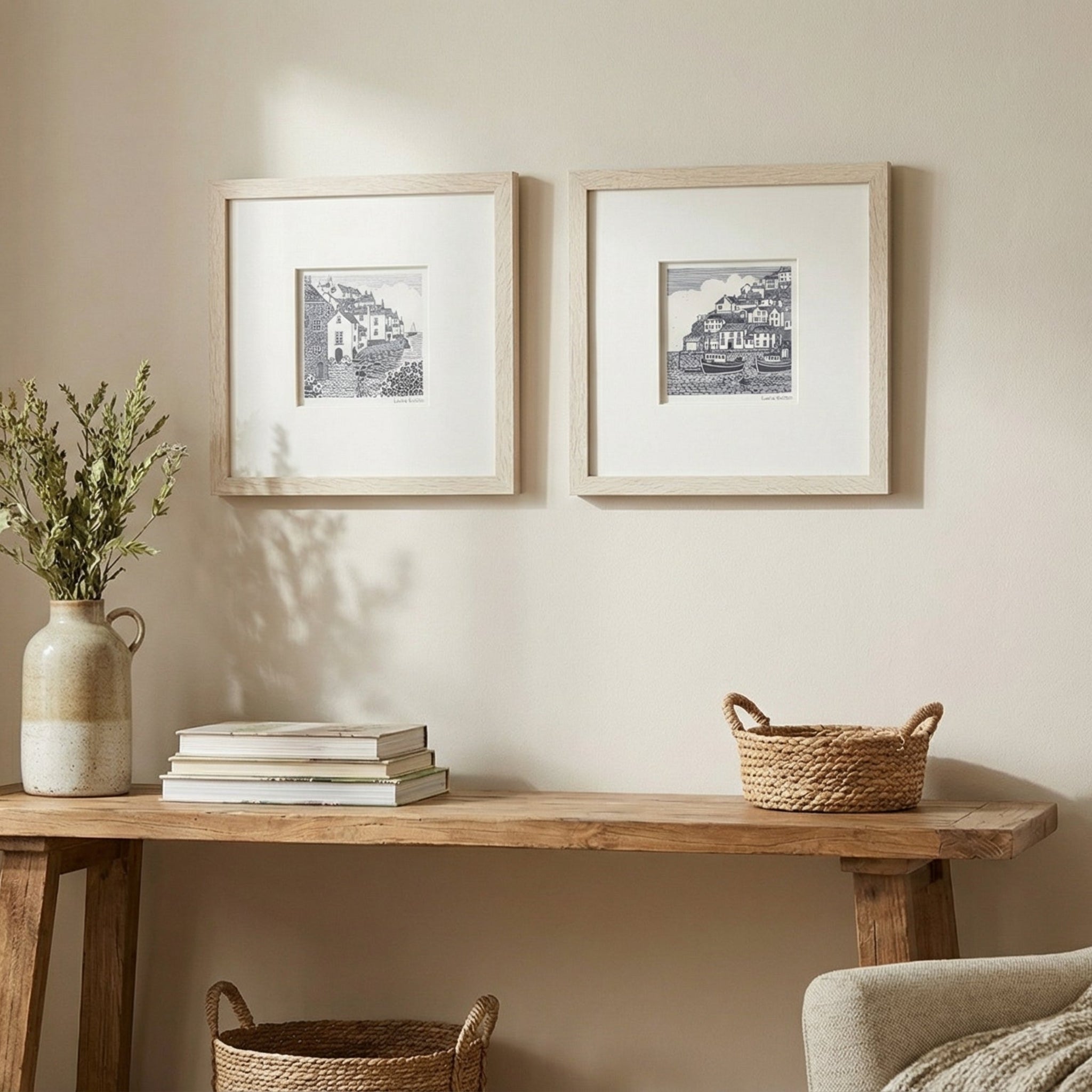 Nest living room with wooden console table, framed pictures, and armchair.