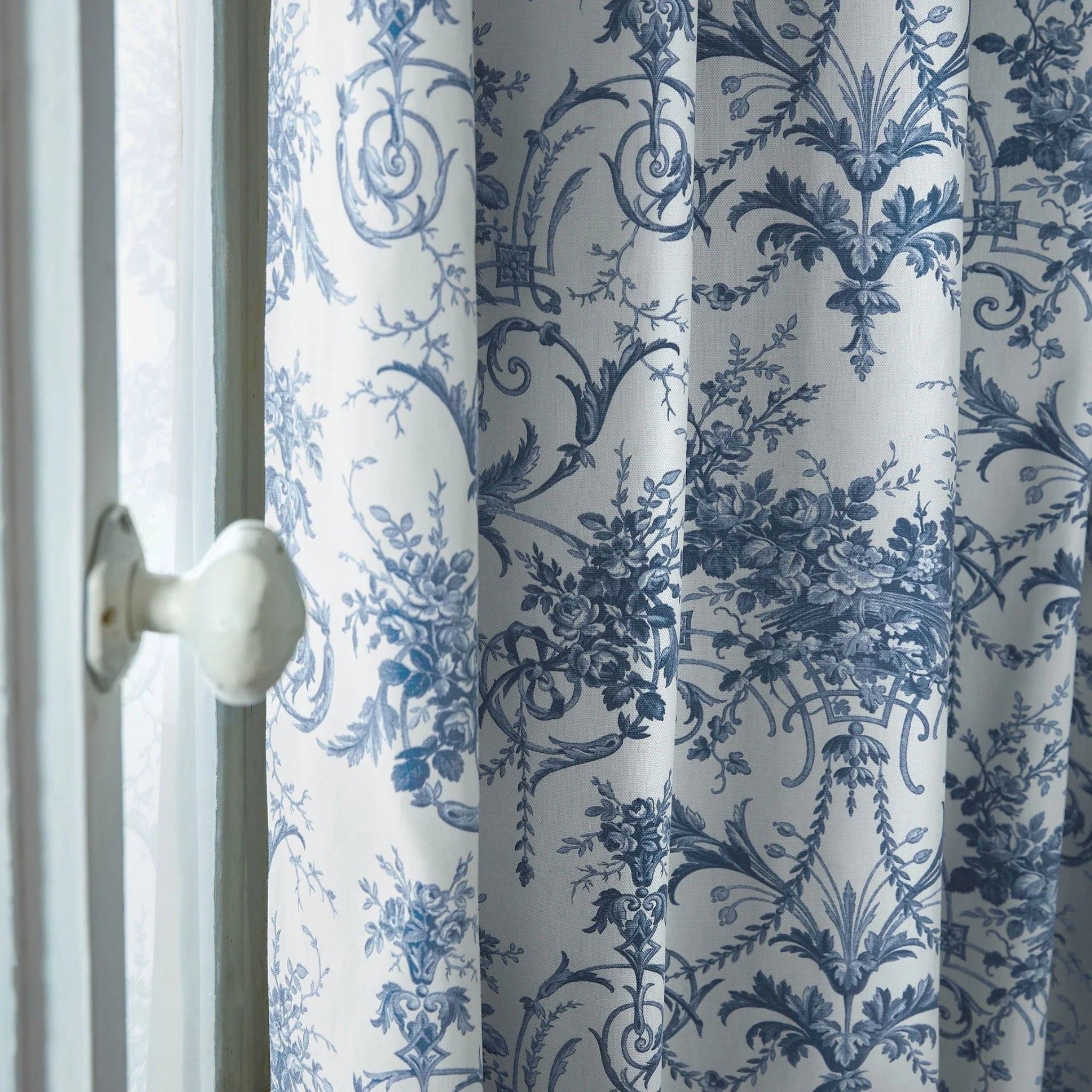 Curtain with blue floral pattern on a white background