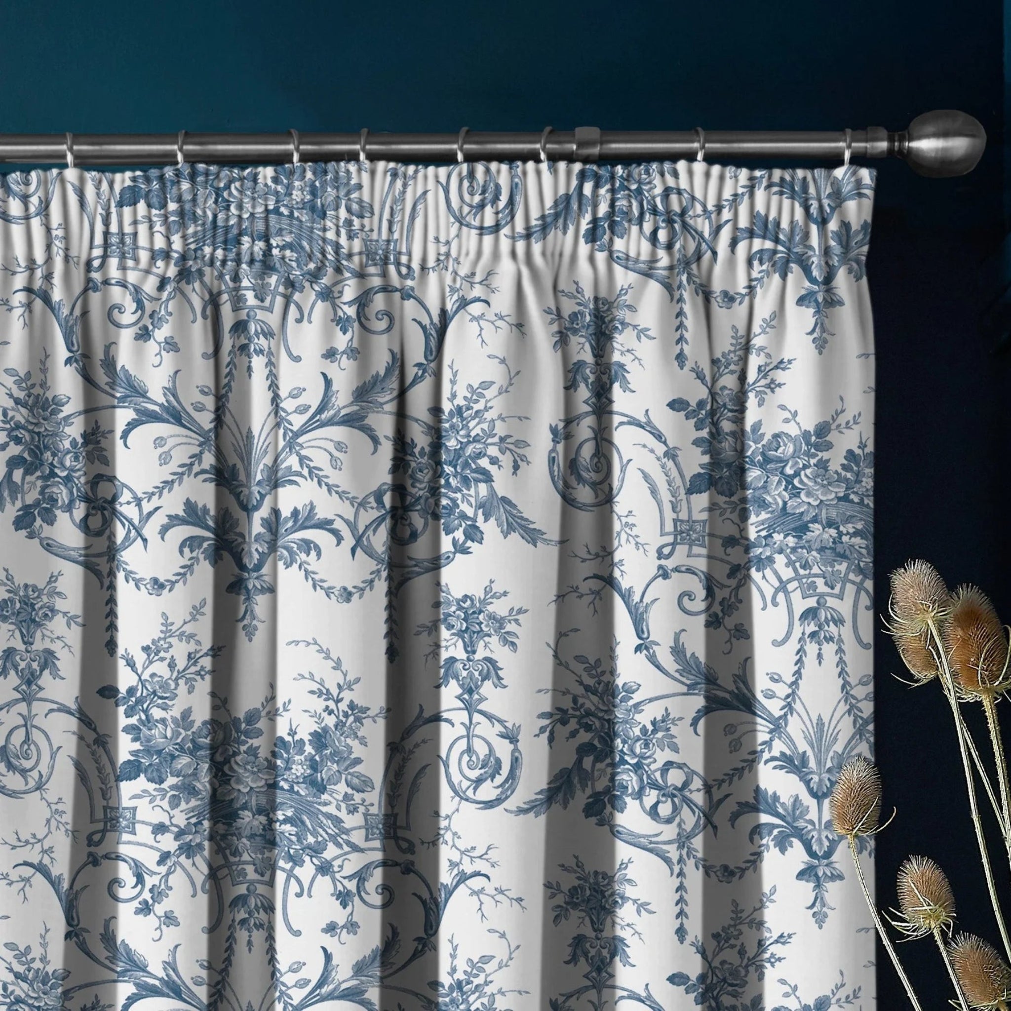 Floral patterned curtain with decorative elements on a dark background