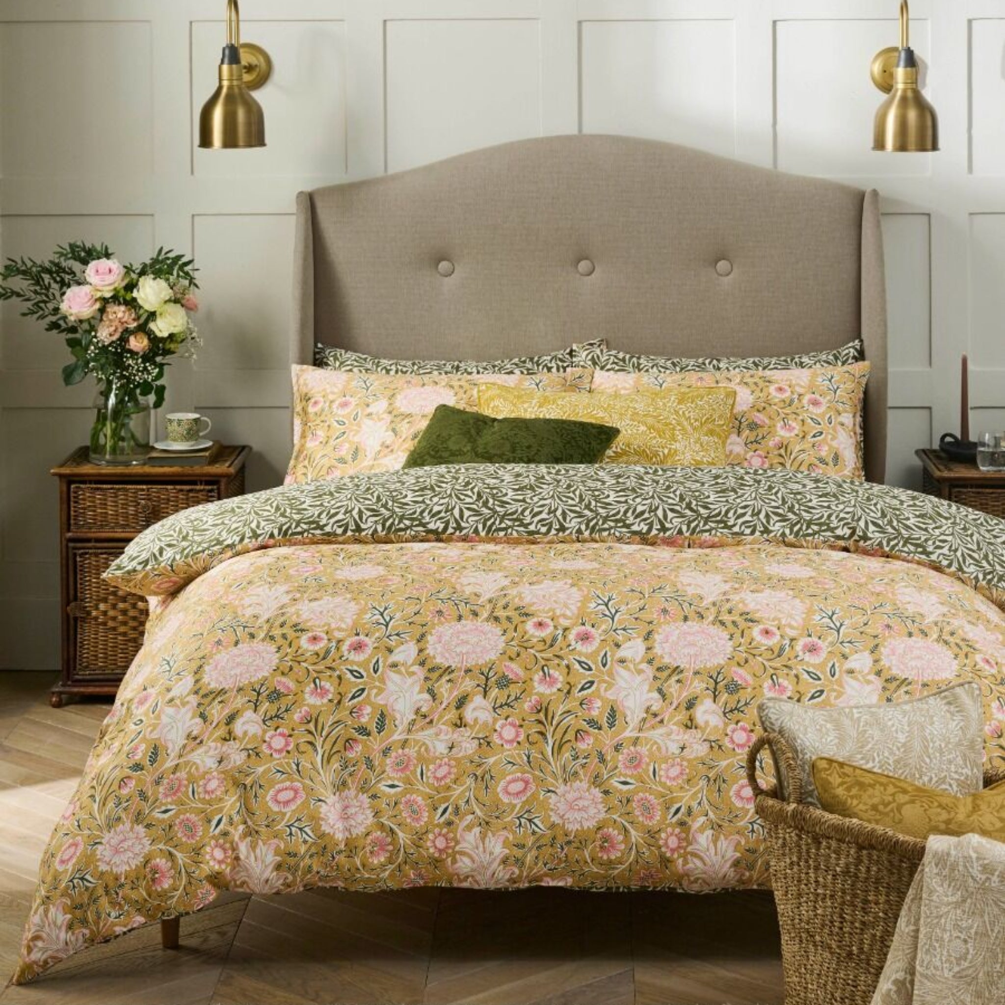 Bedroom with floral bedding, pillows, and a headboard.