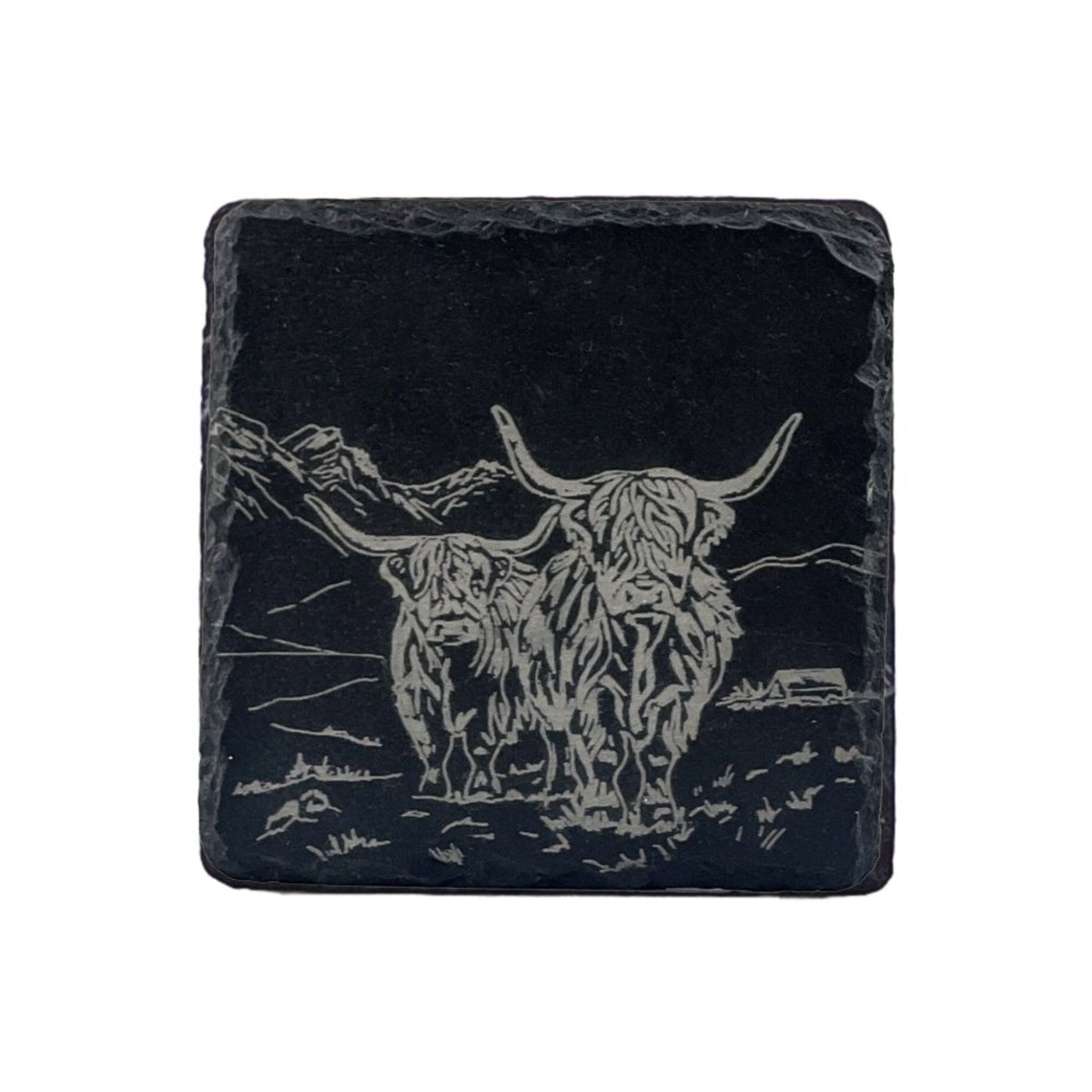 slate coaster with engraved image of a highland cow on a slate grey background