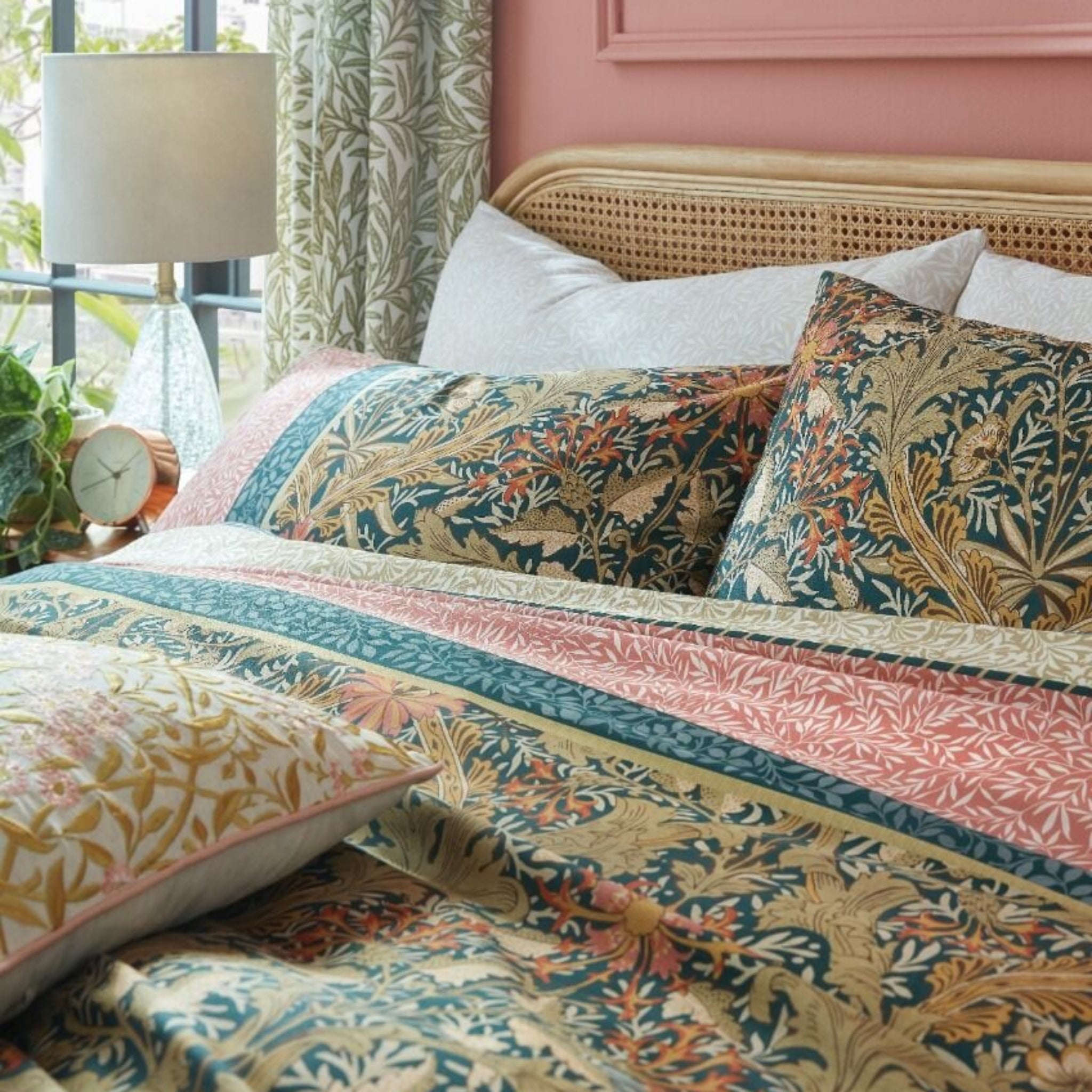 Bedroom with floral bedding and pink headboard
