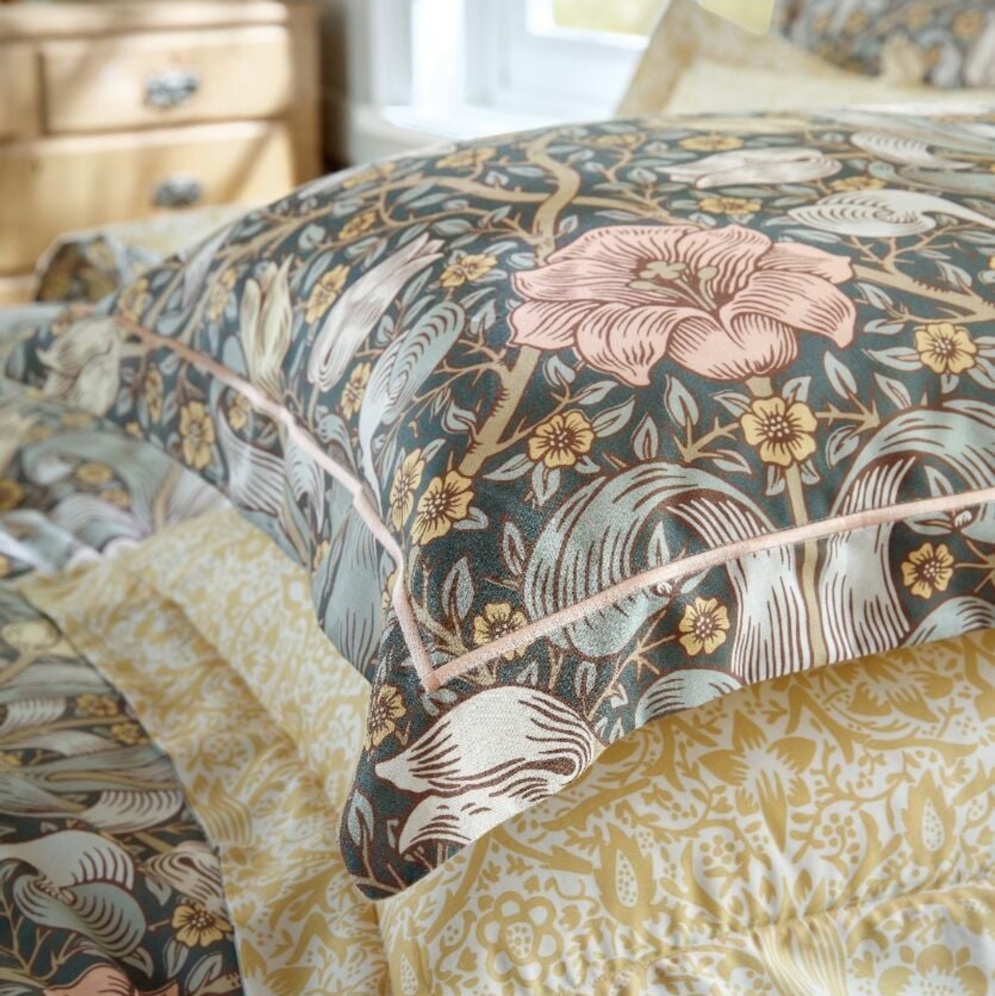 Floral patterned bedding set on a bed with a blurred background