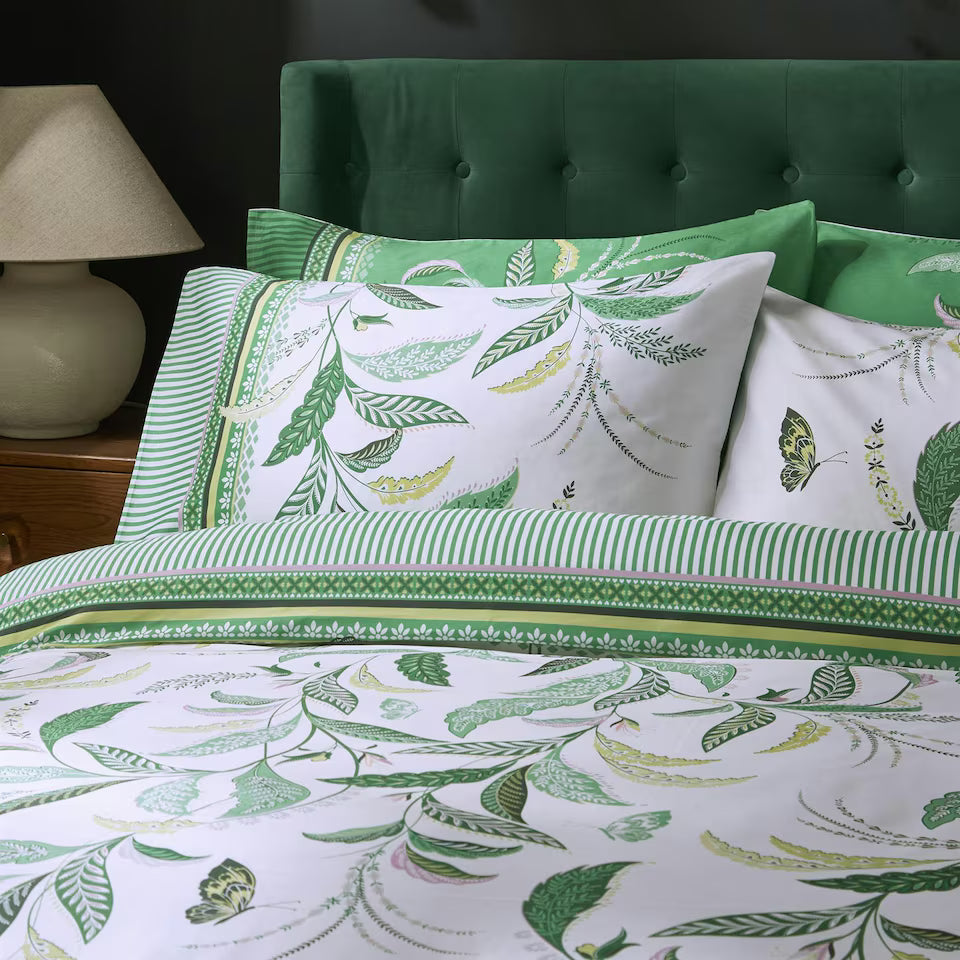 a bed with green and white bedding