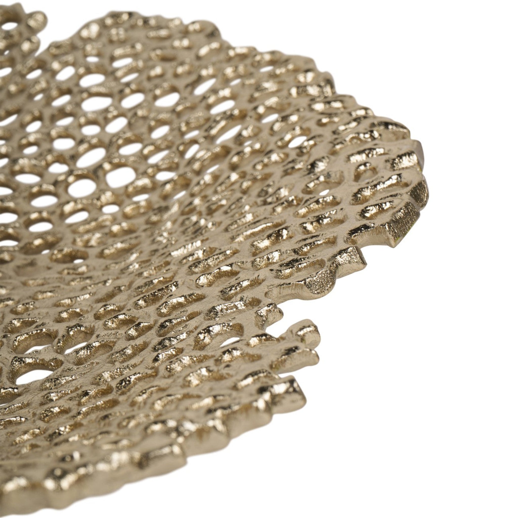 Close-up of a textured gold decorative object on a white background