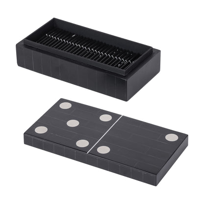Black domino set with pieces and a storage box on a white background