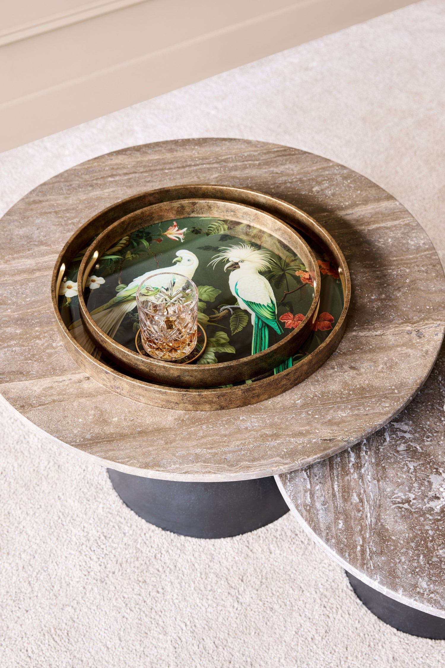 Round wooden table with a decorative inset featuring parrots and a glass vase.