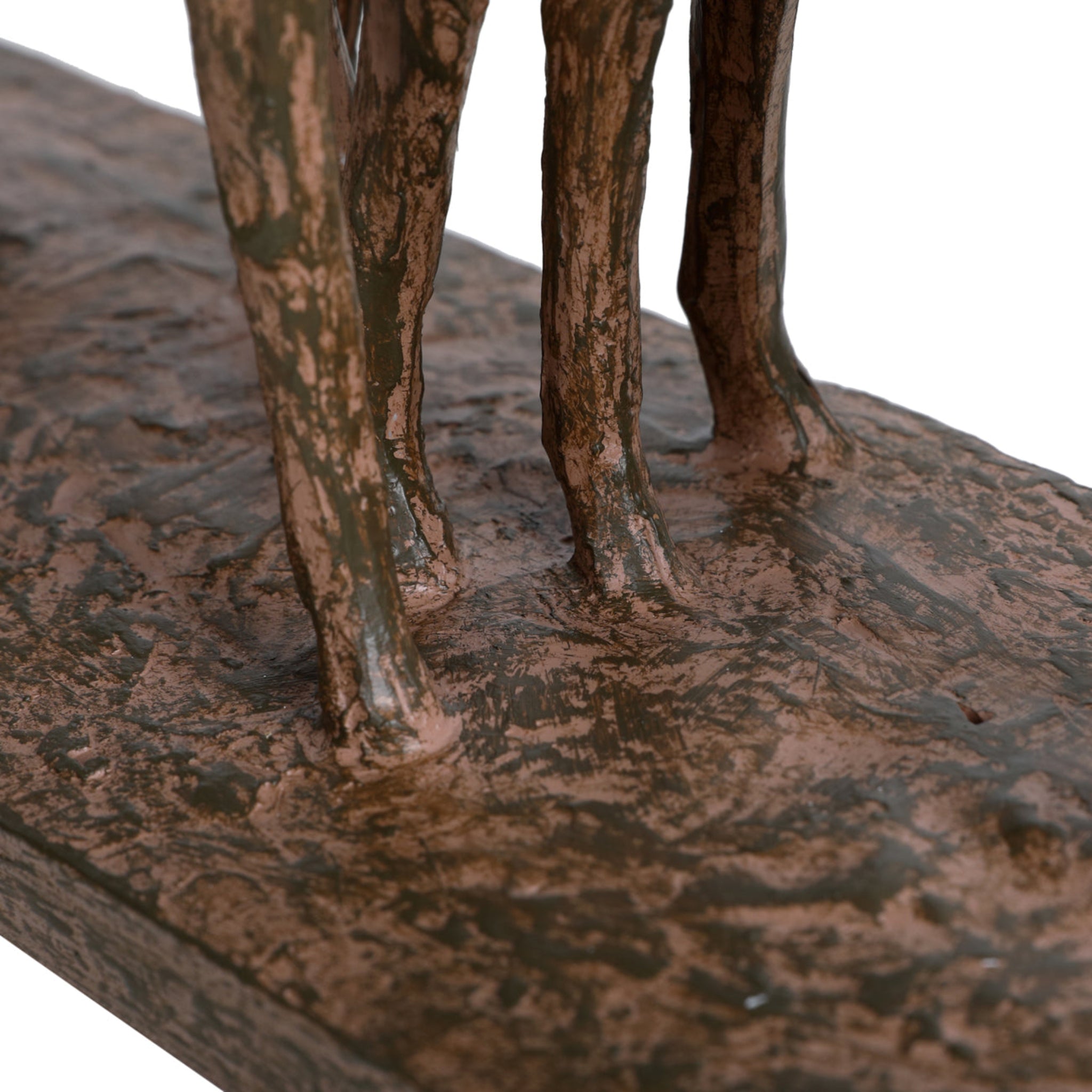 Bronze statue of a figure on a rocky surface