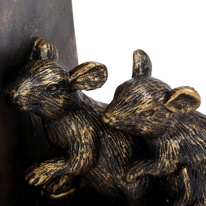 Bronze sculpture of two rats on a dark background