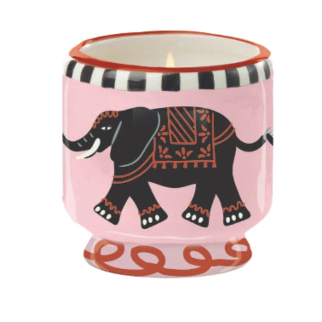 Candle in a pink holder with an elephant design on a white background