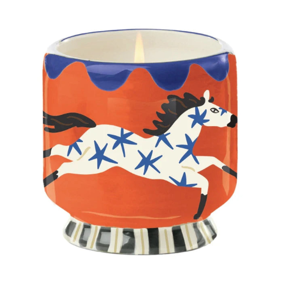 Candle in a decorative holder with a horse design on an orange background