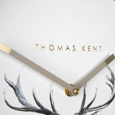 Thomas Kent 12" Wild Stag Wall Clock Up Close on Hands and Logo