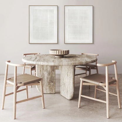 Dining room with marble table and wooden chairs against a light gray wall.