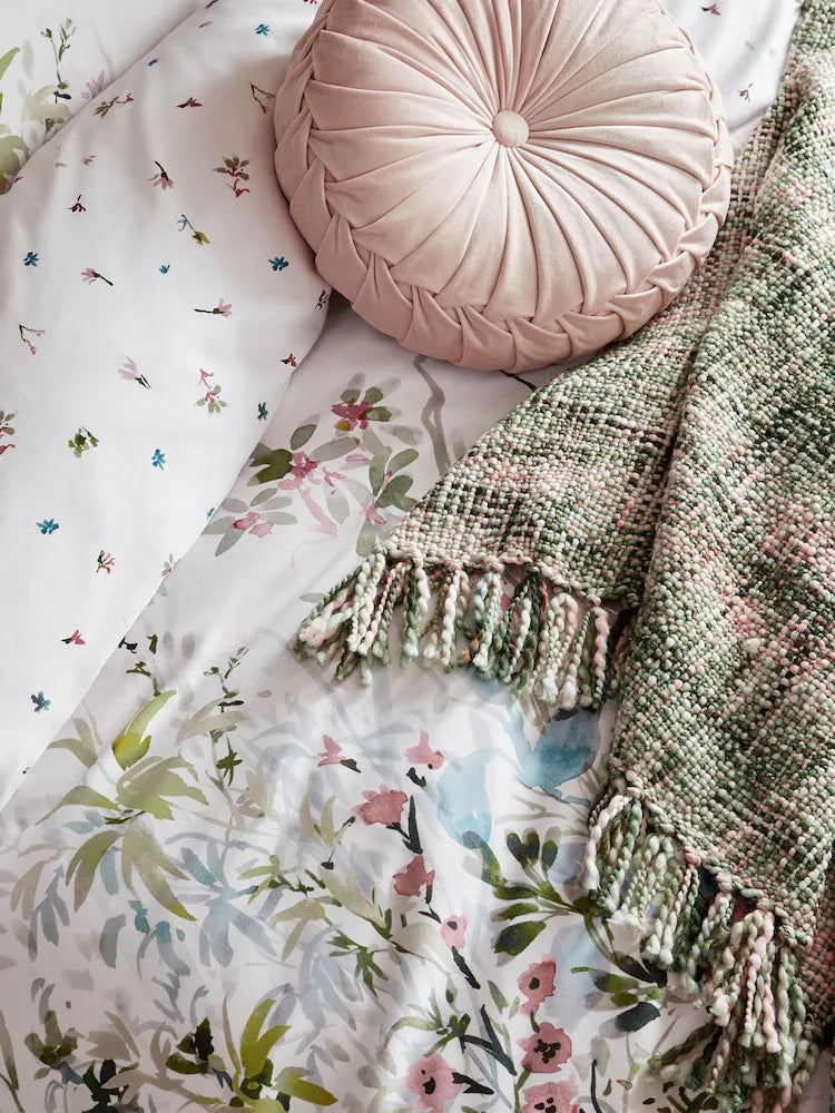 a pillow and blanket on a bed