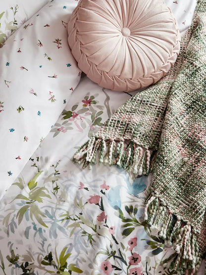 a pillow and blanket on a bed
