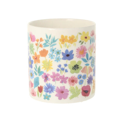 Ceramic planter with colorful floral pattern on a white background