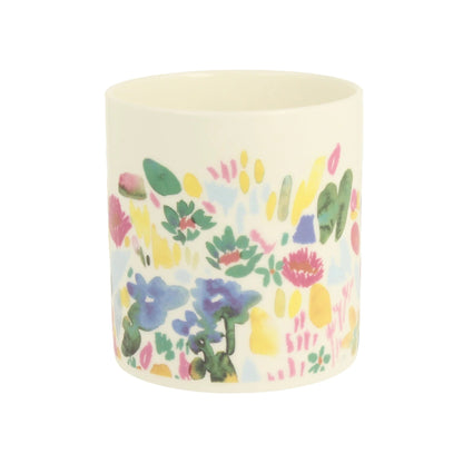 Candle with colorful floral pattern on a white background