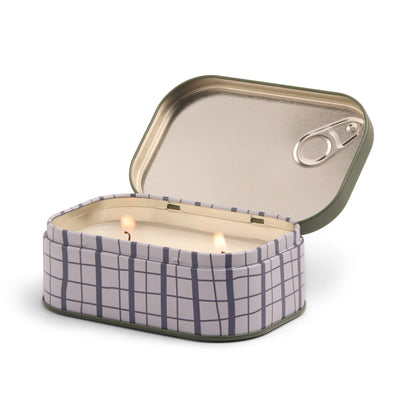 a tin with two lit candles
