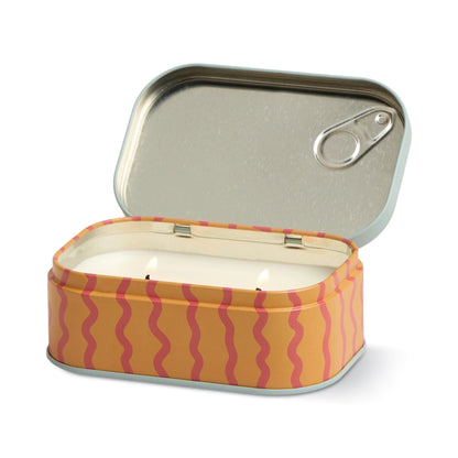Candle in a tin with wavy pattern on a white background