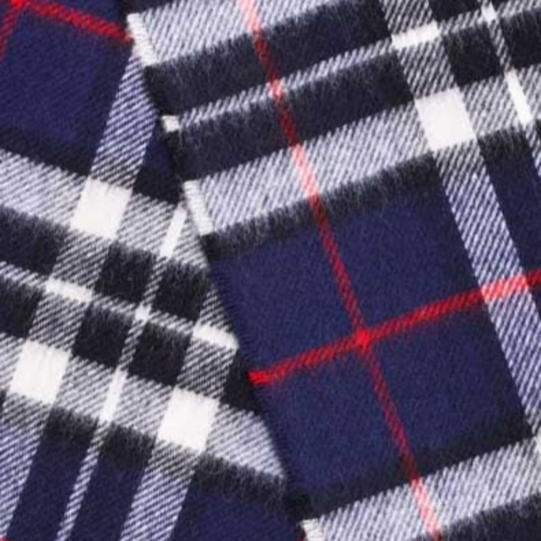 Close-up of plaid fabric with blue, red, and white colors.