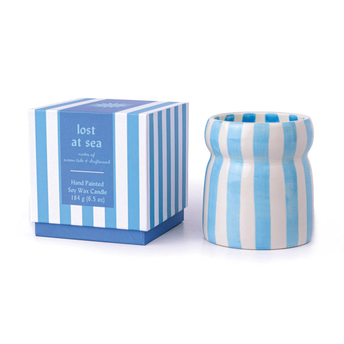 Blue and white striped candle with matching packaging on a white background