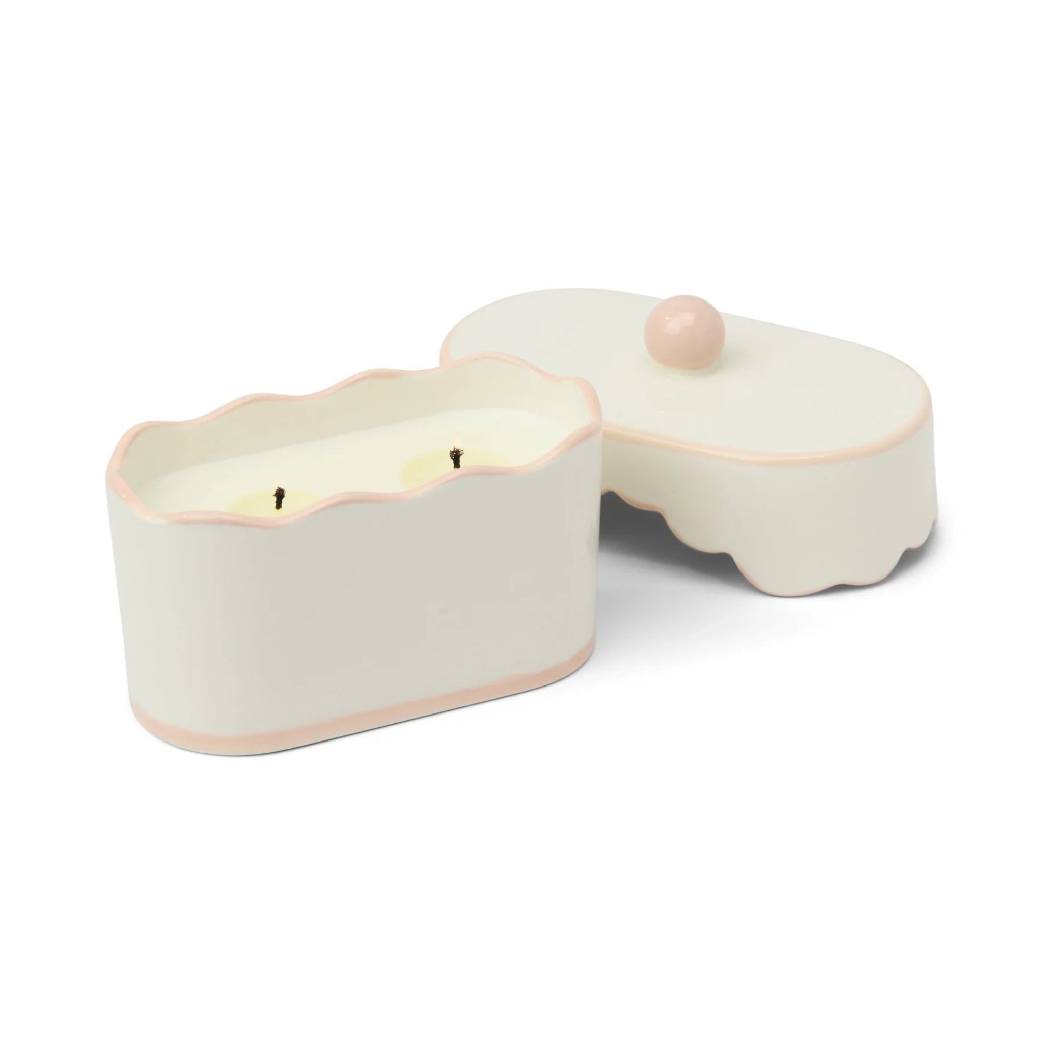 Ceramic candle holder with a light pink lid on a white background
