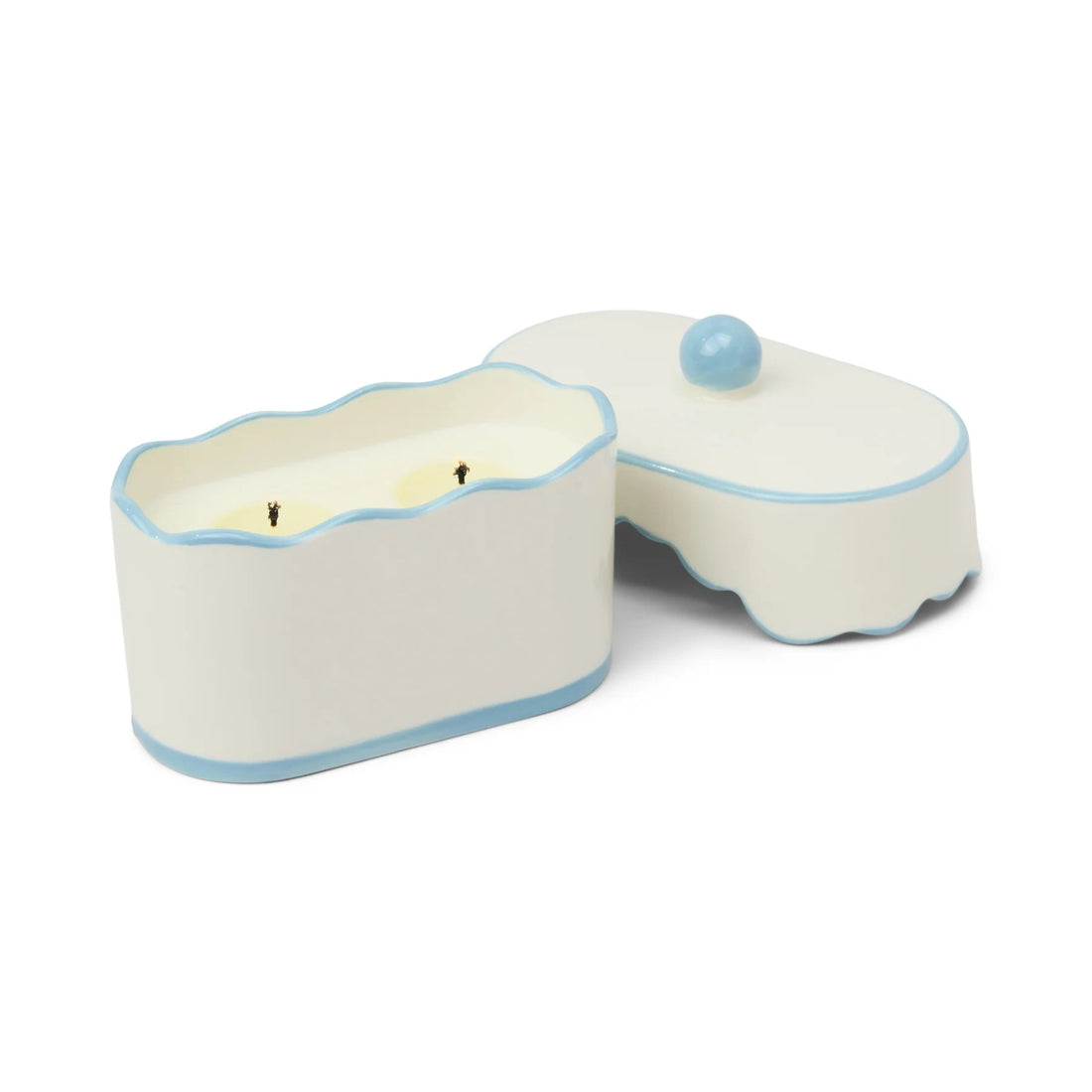 Ceramic candle holder with a candle inside on a white background