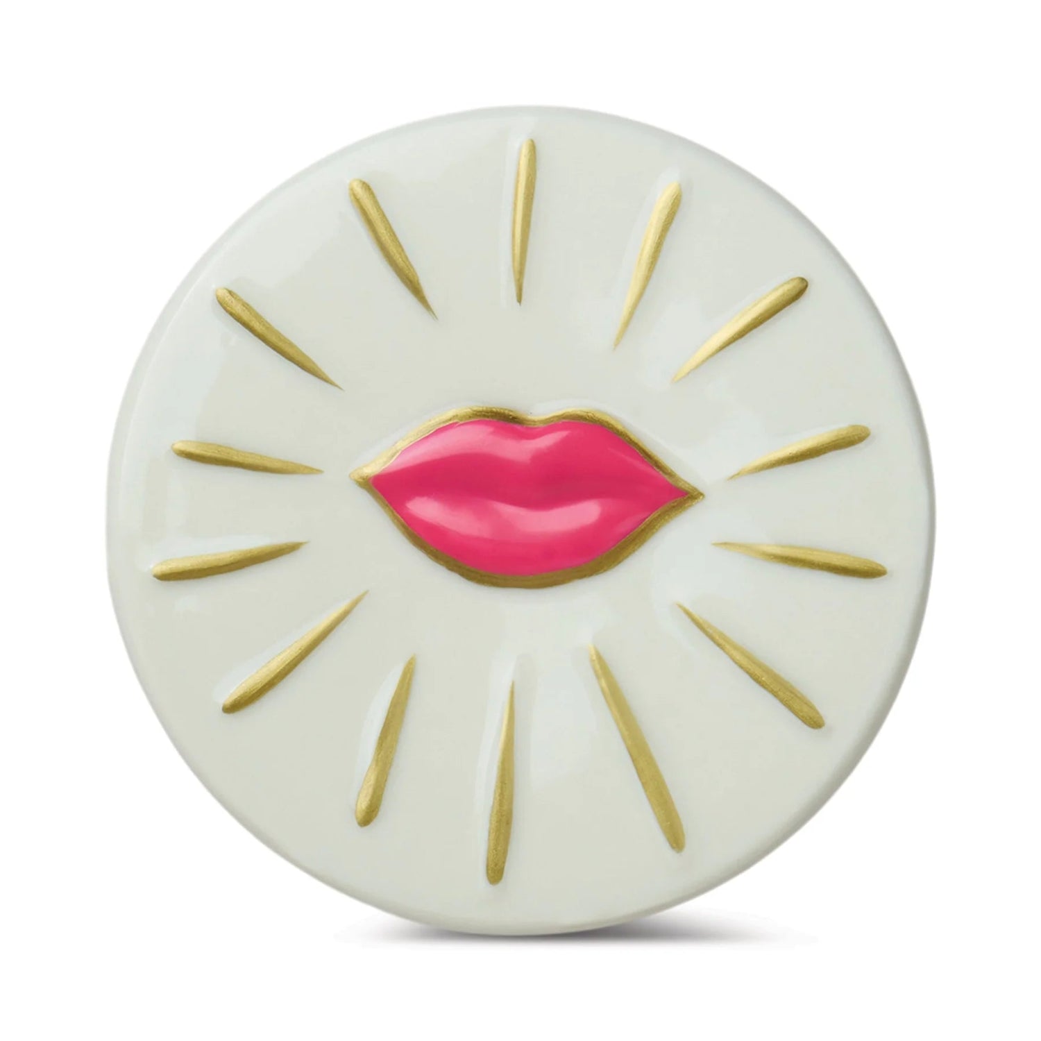 Round white object with pink lips and gold accents on a white background