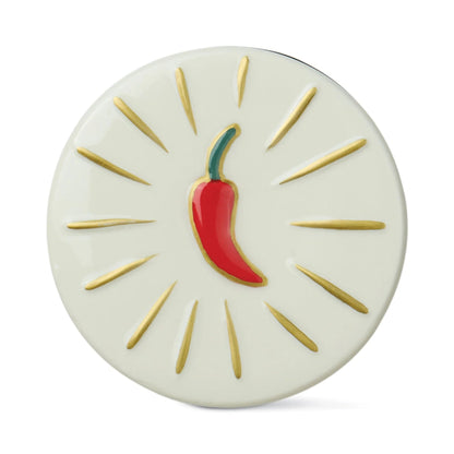 Round ceramic coaster with a red chili pepper design on a white background